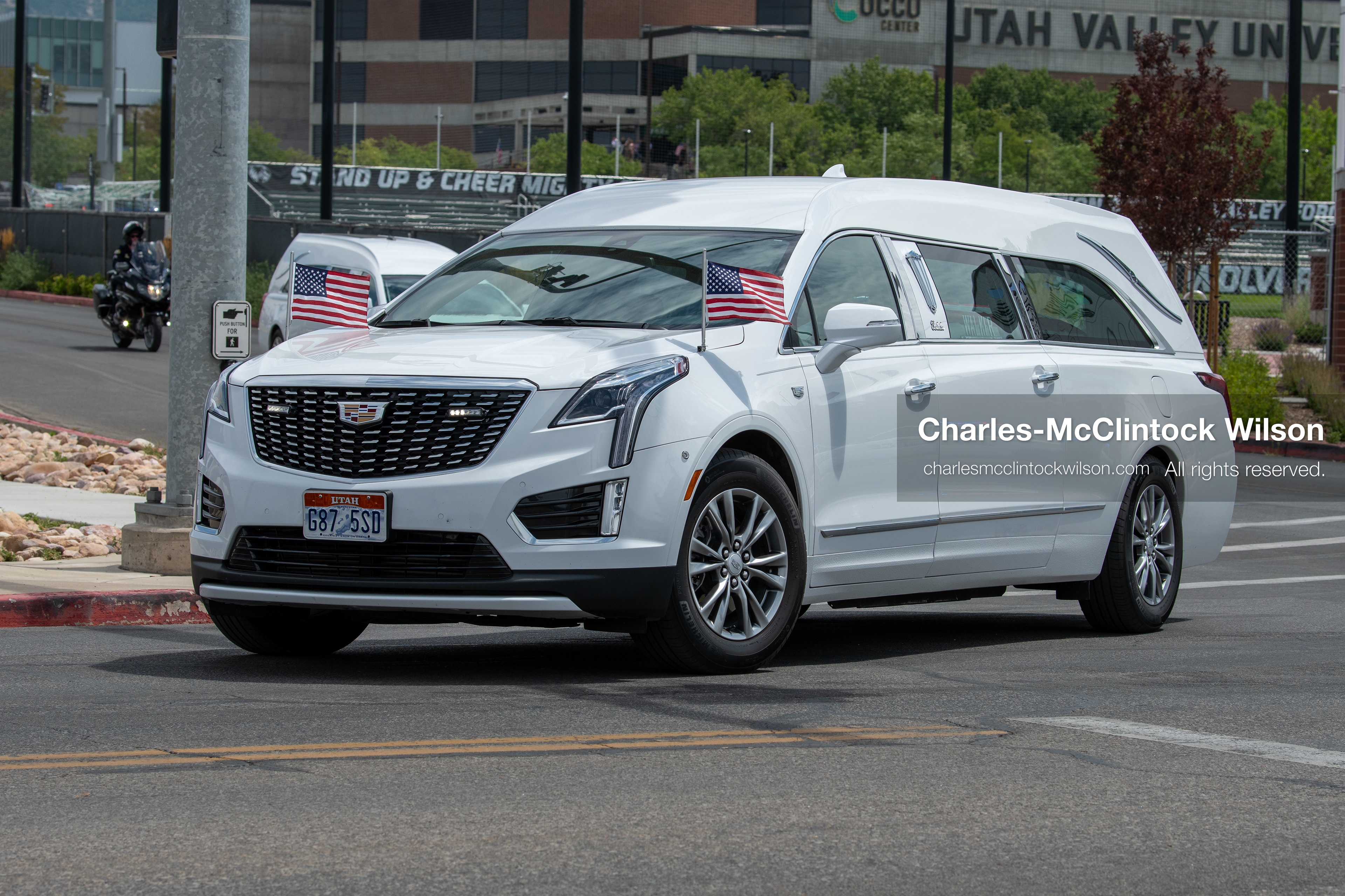 A white Cadillac hearse leads a vehicle procession down the street away from the UCCU Center at Utah Valley University in Orem, Utah, on Wednesday, July 29, 2026. More than 300 people came to the public memorial ceremony to honor Provo Fire Captain Spencer Long, his wife Katrina, and three of their sons, who died after a flash flood hit their campsite near the Sunglow Campground in Wayne County.(Photo by Charles-McClintock Wilson/Sipa USA)