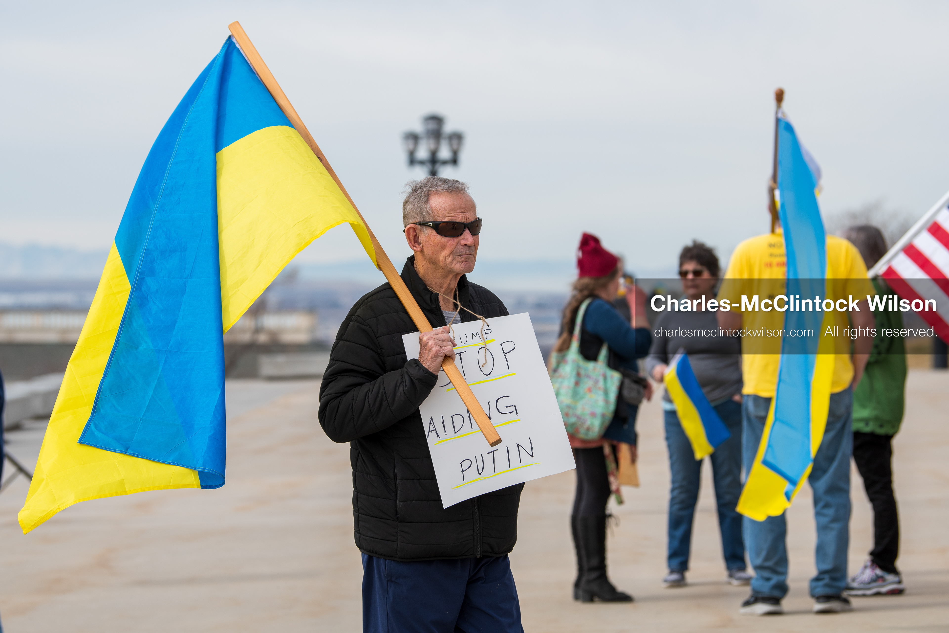February 28, 2026, Salt Lake City, Utah, USA: A demonstrator wears a sign reading Trump Stop Aiding Putin during the Stand With Ukraine rally at the Utah State Capitol. The gathering marked the four year anniversary of the full scale Russian invasion of Ukraine and brought community members together in support of Ukrainians and local humanitarian efforts. (Credit Image: © Charles McClintock Wilson/ZUMA Press Wire)
