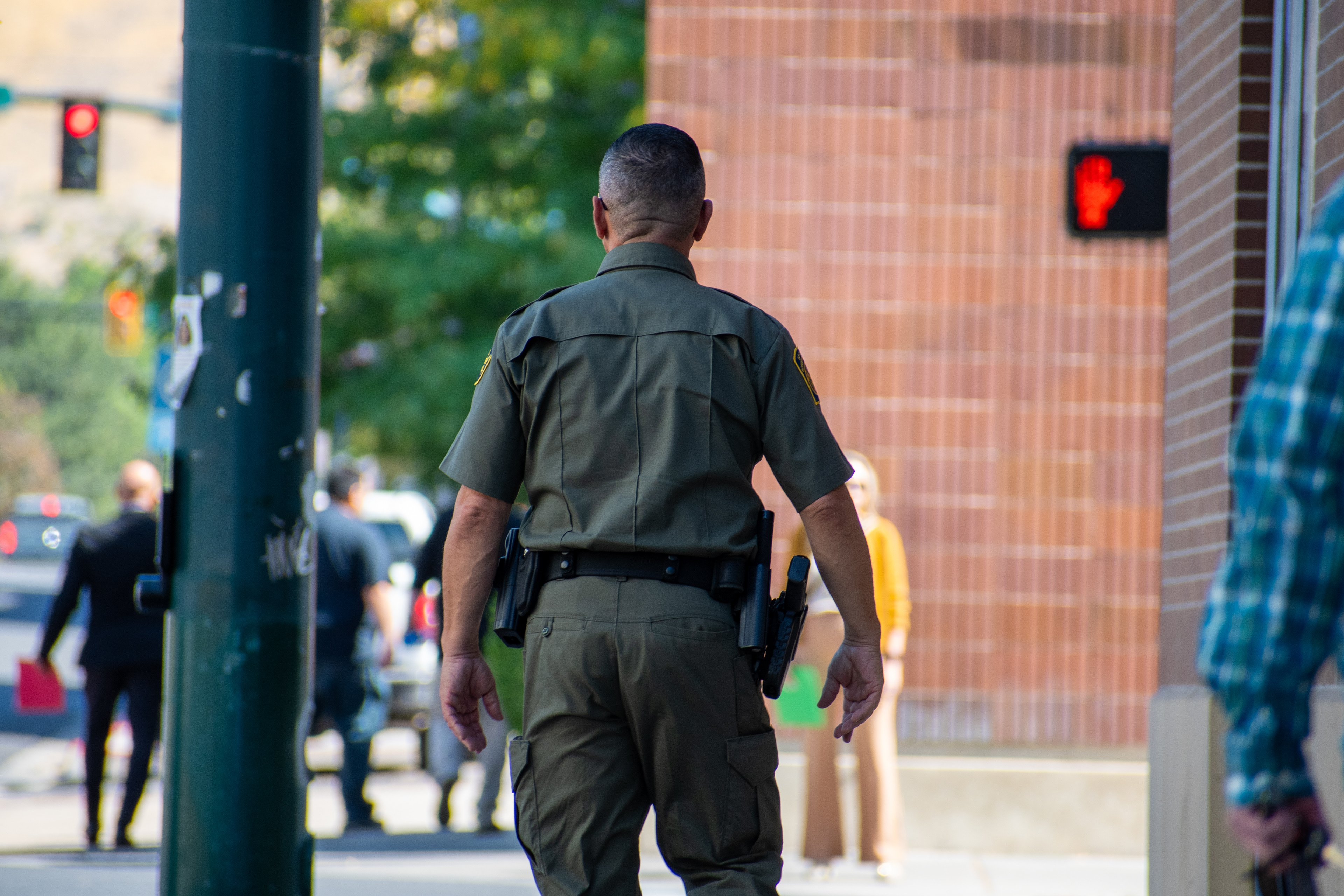 A U.S. Border Patrol agent walks near the Utah Valley Convention Center during a Department of Homeland Security career expo focused on recruiting law enforcement and security personnel. Photograph by Charles‑McClintock Wilson / ZUMA Press Wire