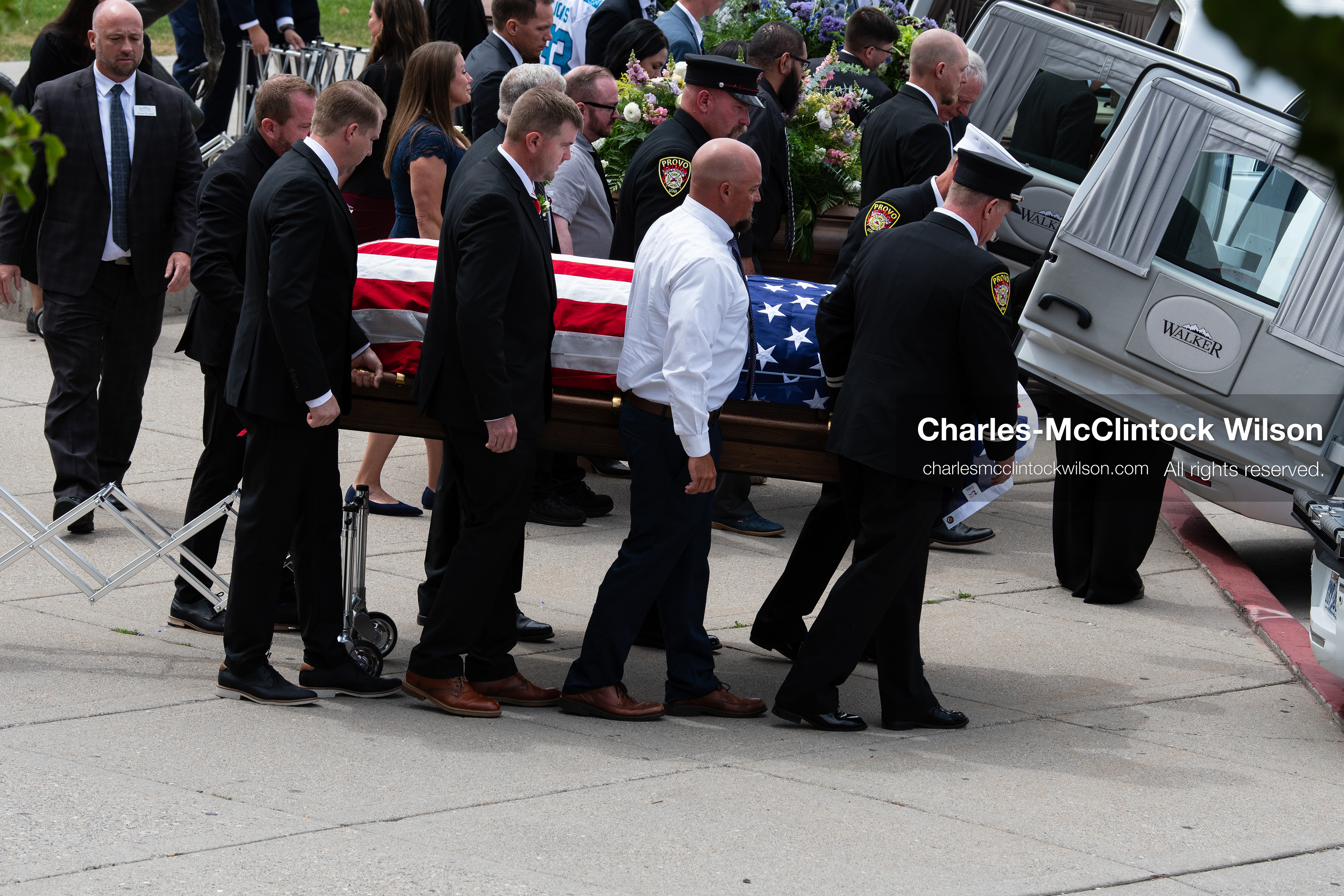 Firefighters and pallbearers load the flag-draped casket of Provo Fire Captain Spencer Long into a white hearse outside the UCCU Center at Utah Valley University in Orem, Utah, on Wednesday, July 29, 2026. More than 300 people came to the public memorial ceremony to honor Captain Long, his wife Katrina, and three of their sons, who died after a flash flood hit their campsite near the Sunglow Campground in Wayne County. (Photo by Charles-McClintock Wilson/Sipa USA)