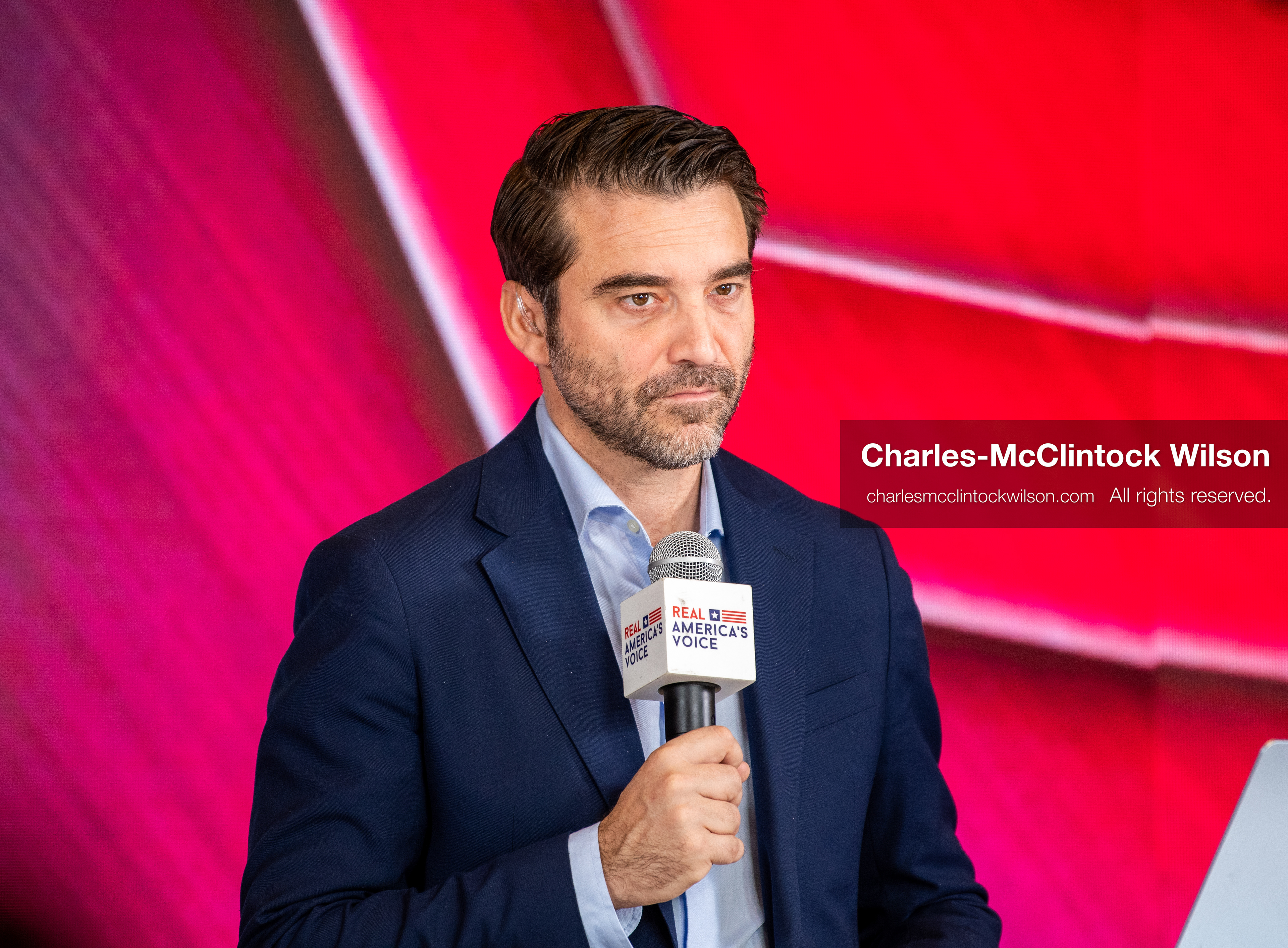 December 18, 2025, Phoenix, Arizona, USA: Javier Negre, a far-right Spanish media entrepreneur and the founder and president of the EDA Group, holds a Real Americas Voice microphone at the Turning Point USA AmericaFest 2025 event at the Phoenix Convention Center, the first edition of the gathering held since the death of Charlie Kirk. (Credit Image: (c) Charles-McClintock Wilson/ZUMA Press Wire)