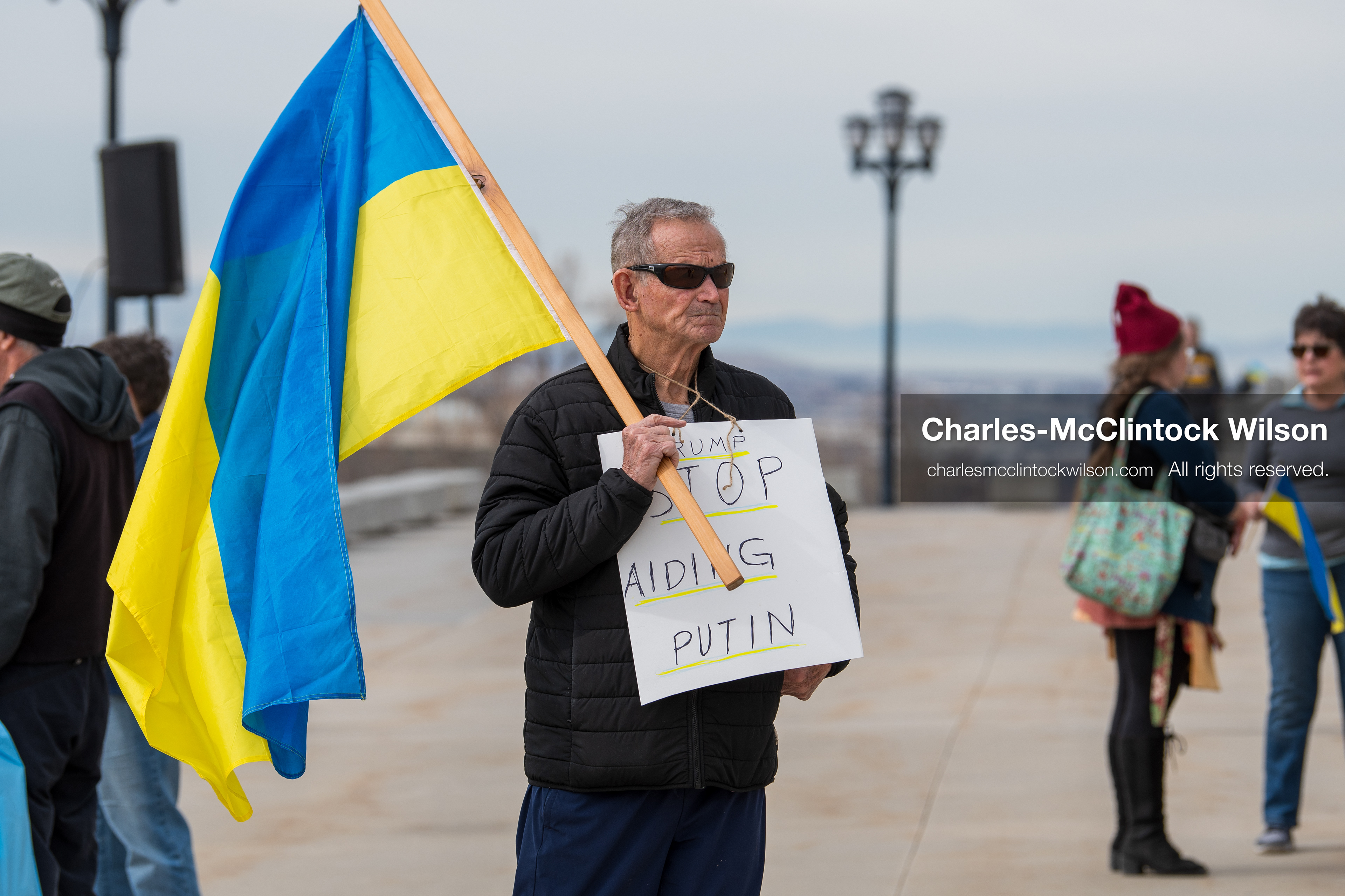 February 28, 2026, Salt Lake City, Utah, USA: A demonstrator wears a sign reading Trump Stop Aiding Putin during the Stand With Ukraine rally at the Utah State Capitol. The gathering marked the four year anniversary of the full scale Russian invasion of Ukraine and brought community members together in support of Ukrainians and local humanitarian efforts. (Credit Image: © Charles McClintock Wilson/ZUMA Press Wire)