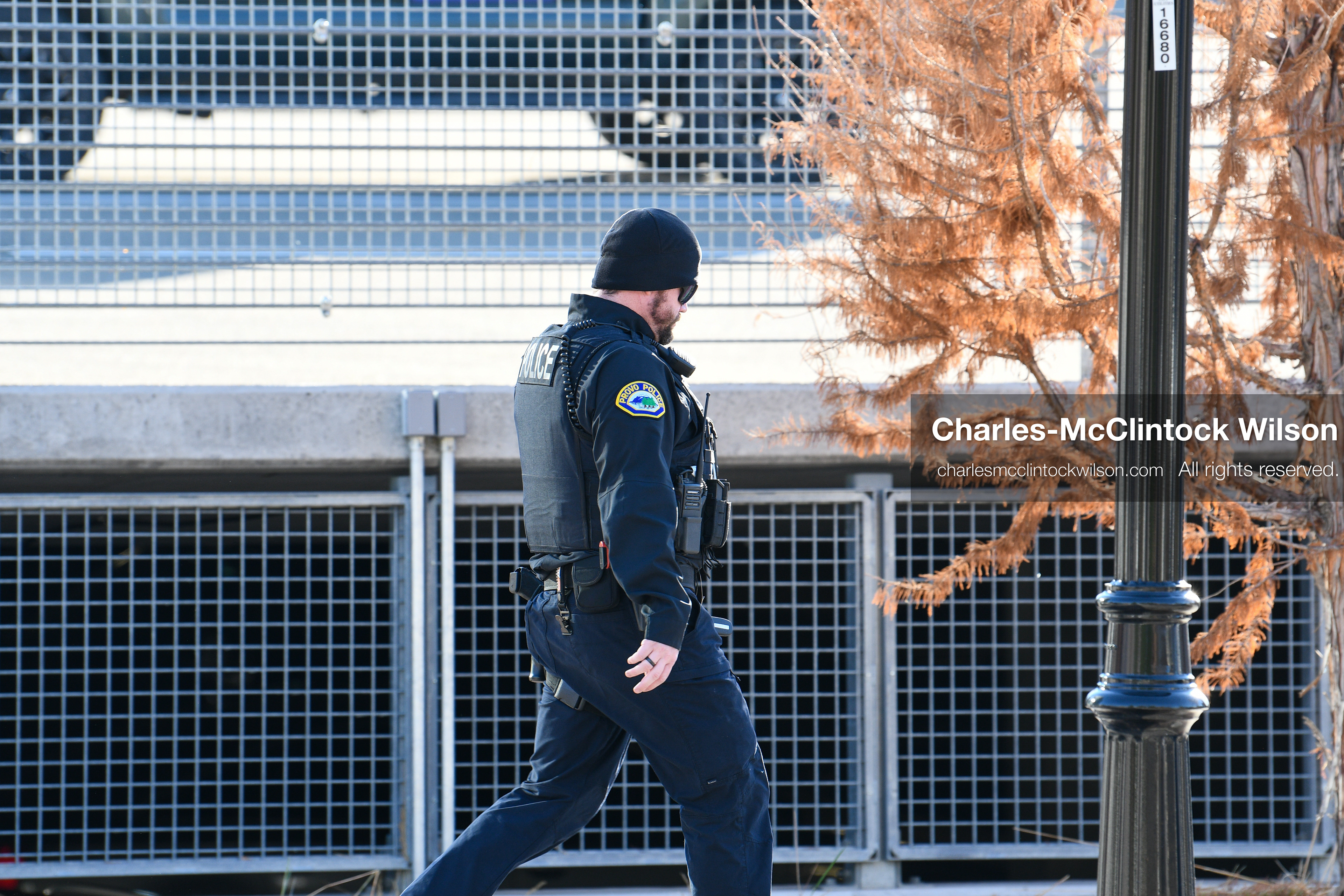 PROVO, UTAH, USA – DECEMBER 11, 2025: A Provo Police officer patrols on foot near the Fourth District Court in Provo during the first in‑person court appearance of Tyler Robinson in the Charlie Kirk murder case. (Credit Image: © Charles‑McClintock Wilson/ZUMA Press Wire)