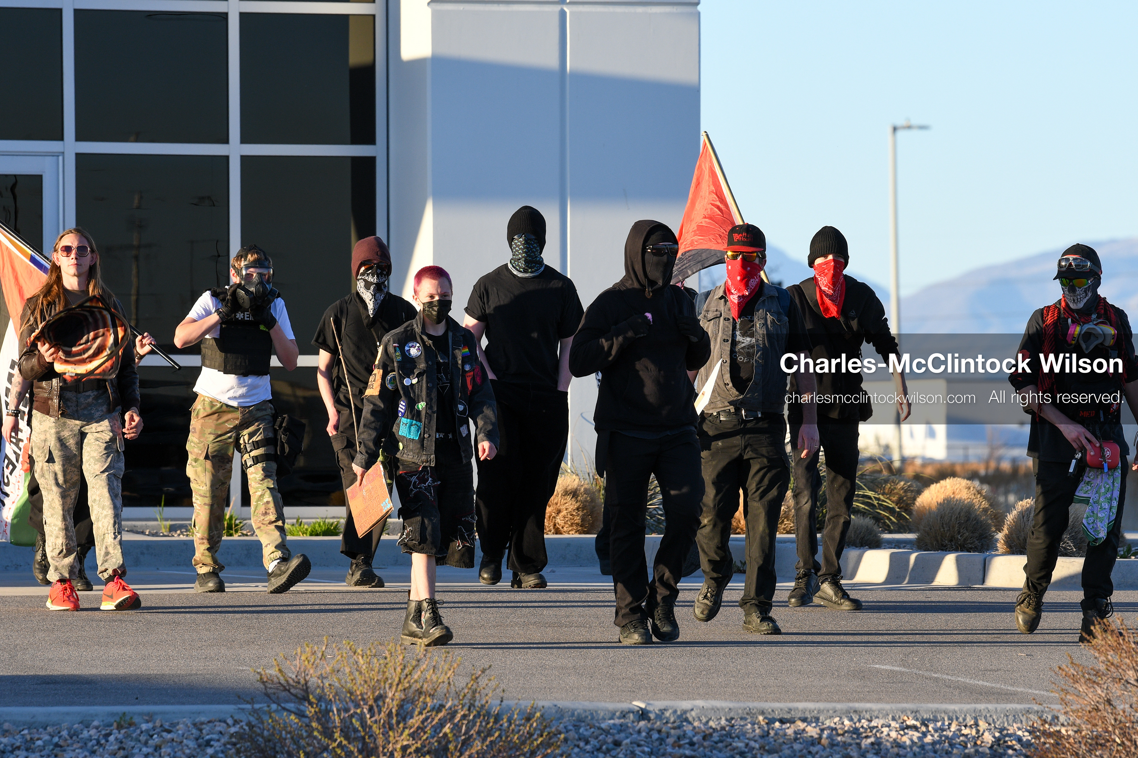 March 18, 2026, Salt Lake City, Utah, USA: Protesters walk near the site of a proposed ICE detention facility on the west side of Salt Lake City. Demonstrators carrying flags and signs moved through the area during the gathering at the warehouse property. (Credit Image: © Charles McClintock Wilson/ZUMA Press Wire)