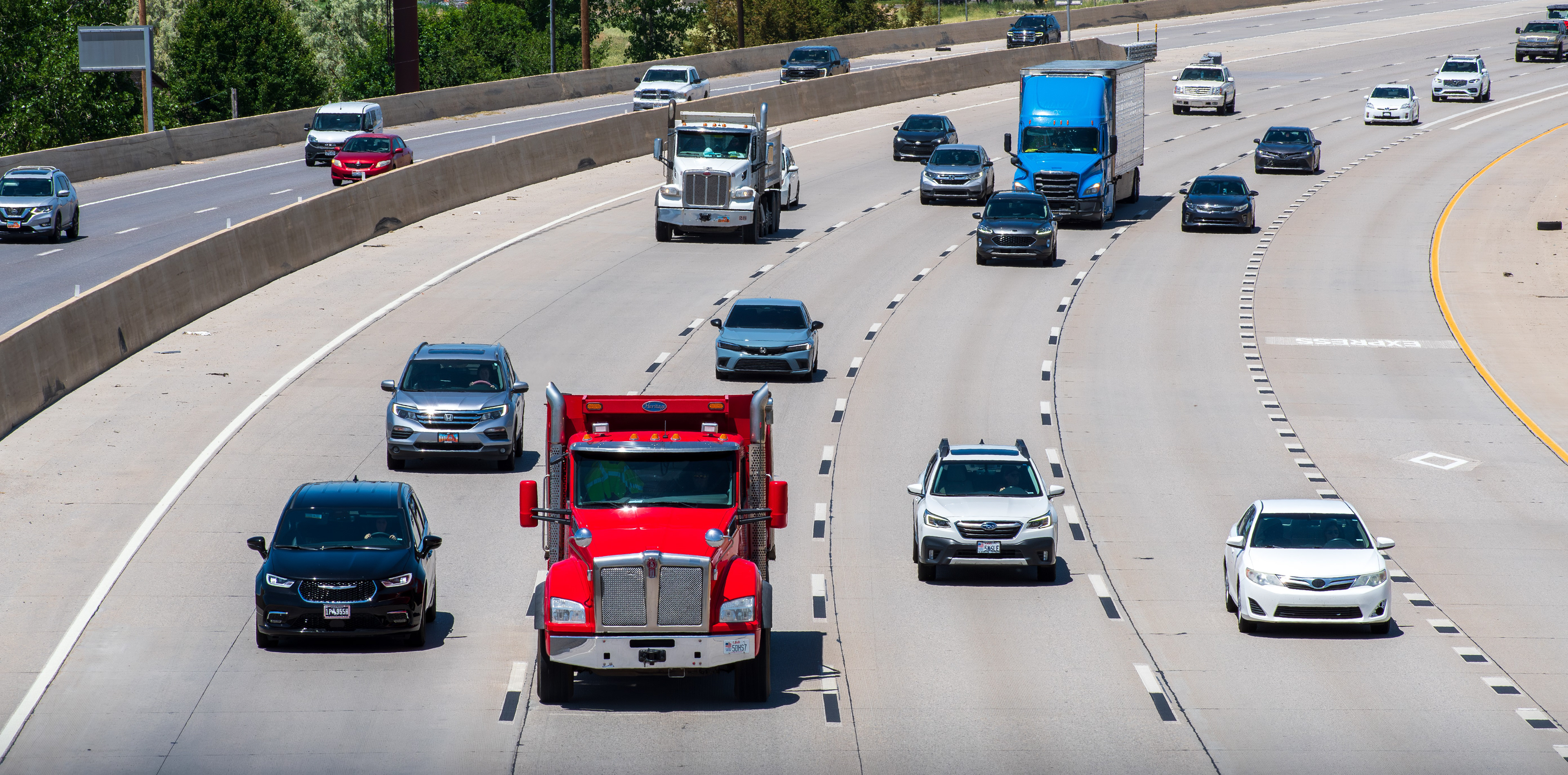 Orem, Utah – June 2, 2025: Multiple vehicles travel along Interstate 15 during daytime, captured from an elevated perspective showing traffic flow and highway infrastructure in the area.