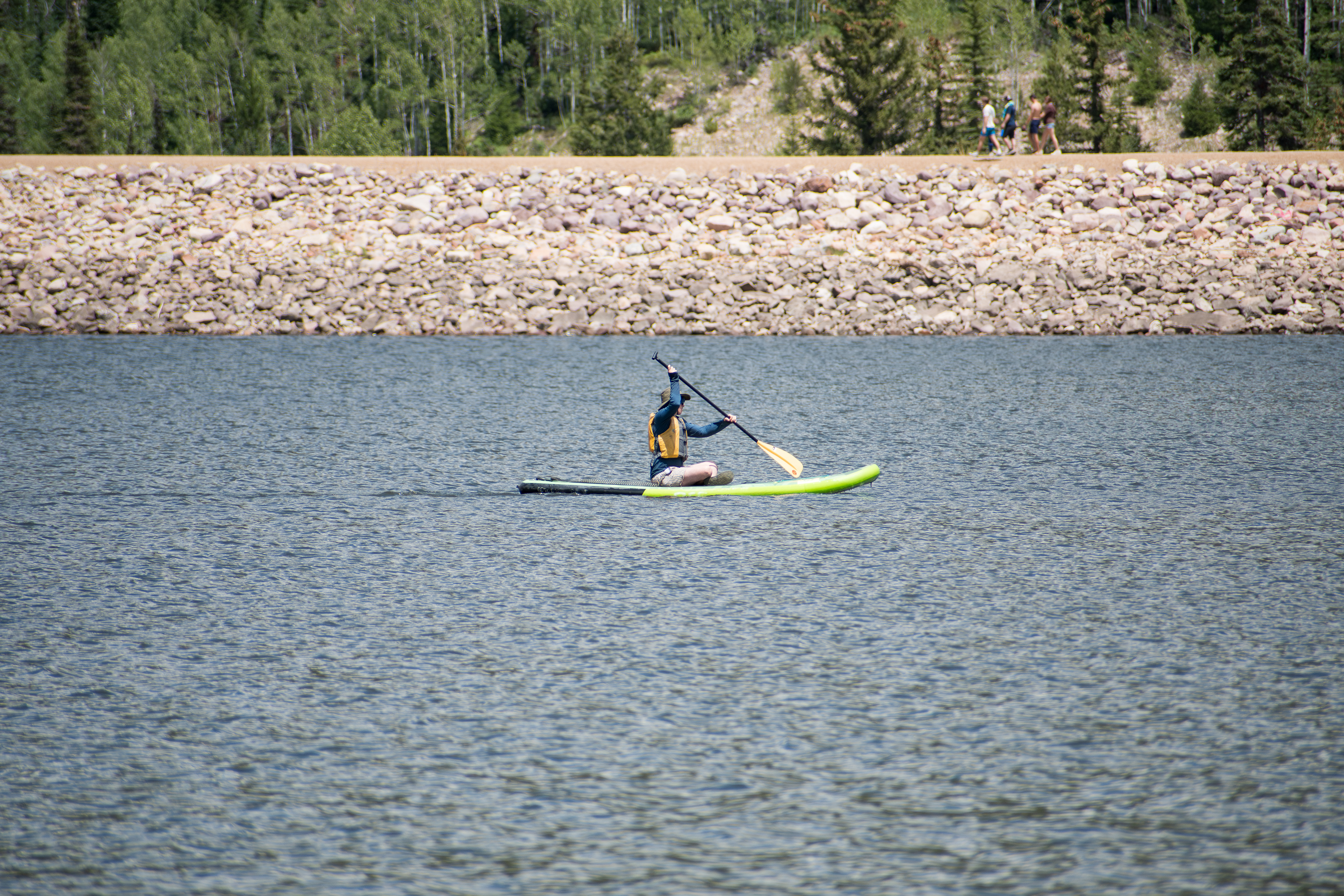 Summit County, Utah – July 20, 2025: A man paddleboards across the water at Smith and Morehouse Reservoir. 