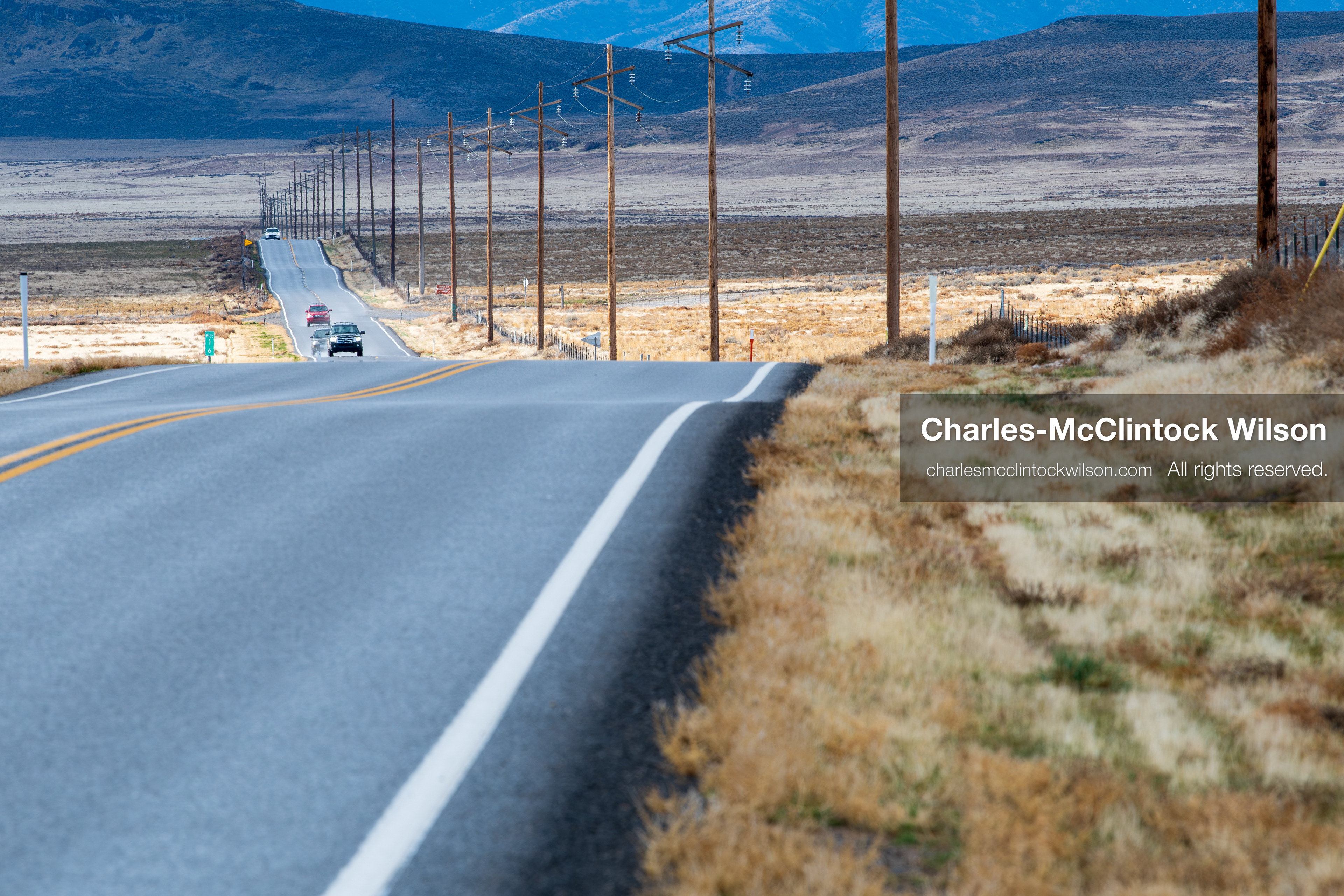January 1, 2026, Saratoga Springs, Utah, USA: Vehicles travel along a rural highway near Utah Lake on January 1, 2026, in Saratoga Springs, Utah, USA. Utility poles flank the road as dry plains and distant mountains frame the landscape under partly cloudy skies. (Credit Image: © Charles-McClintock Wilson/ZUMA Press Wire)