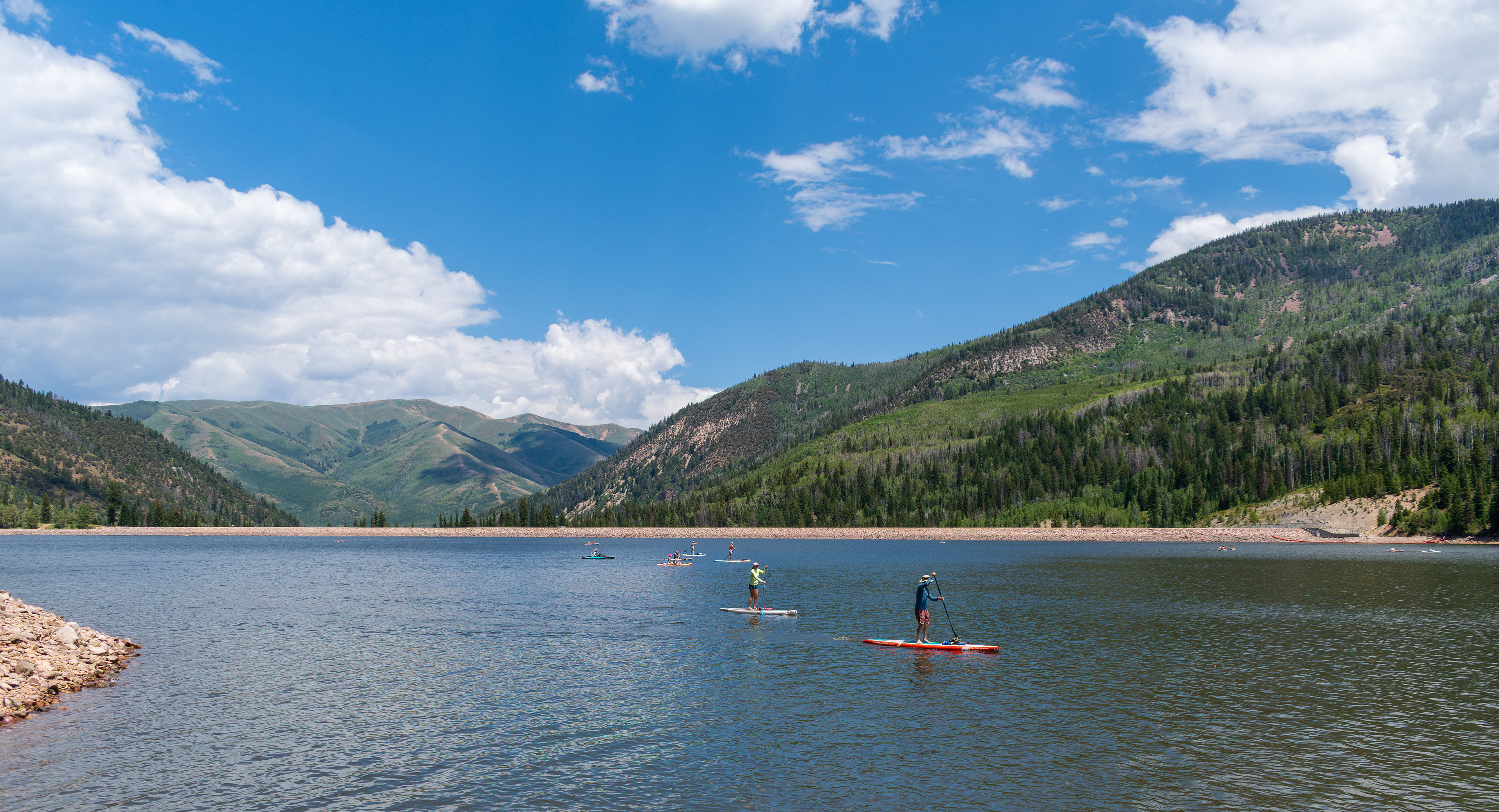 Summit County, Utah – July 20, 2025: People enjoy outdoor recreation on kayaks and paddleboards at Smith and Morehouse Reservoir.