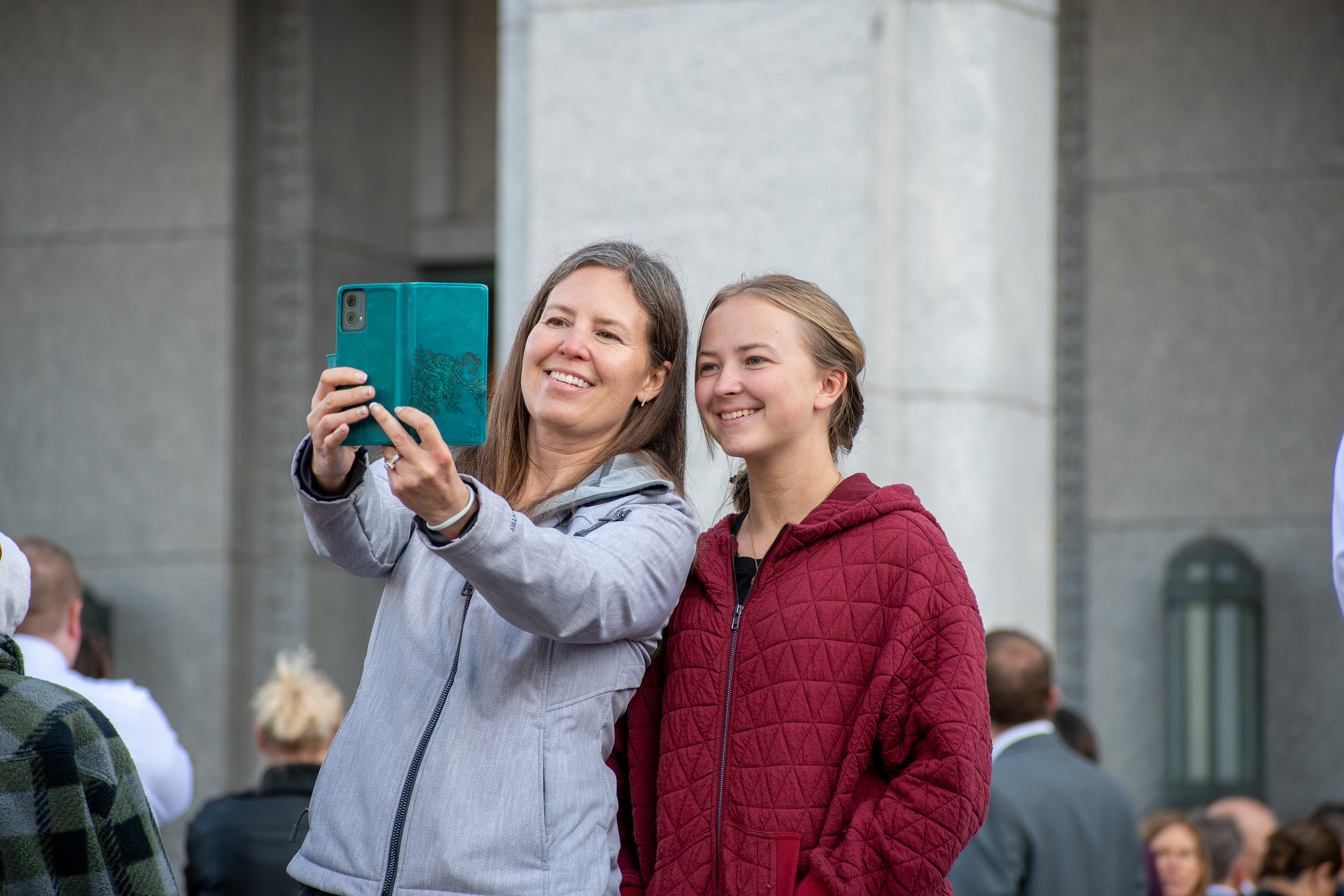October 6, 2025, Salt Lake City, Utah, USA: Two attendees take a selfie outside the Conference Center during the public viewing for Russell M. Nelson, the 17th president of the Church of Jesus Christ of Latter-day Saints. Nelson died at his home in Salt Lake City, Utah, on September 27, 2025, at the age of 101. (Credit Image: © Charles-McClintock Wilson/ZUMA Press Wire)