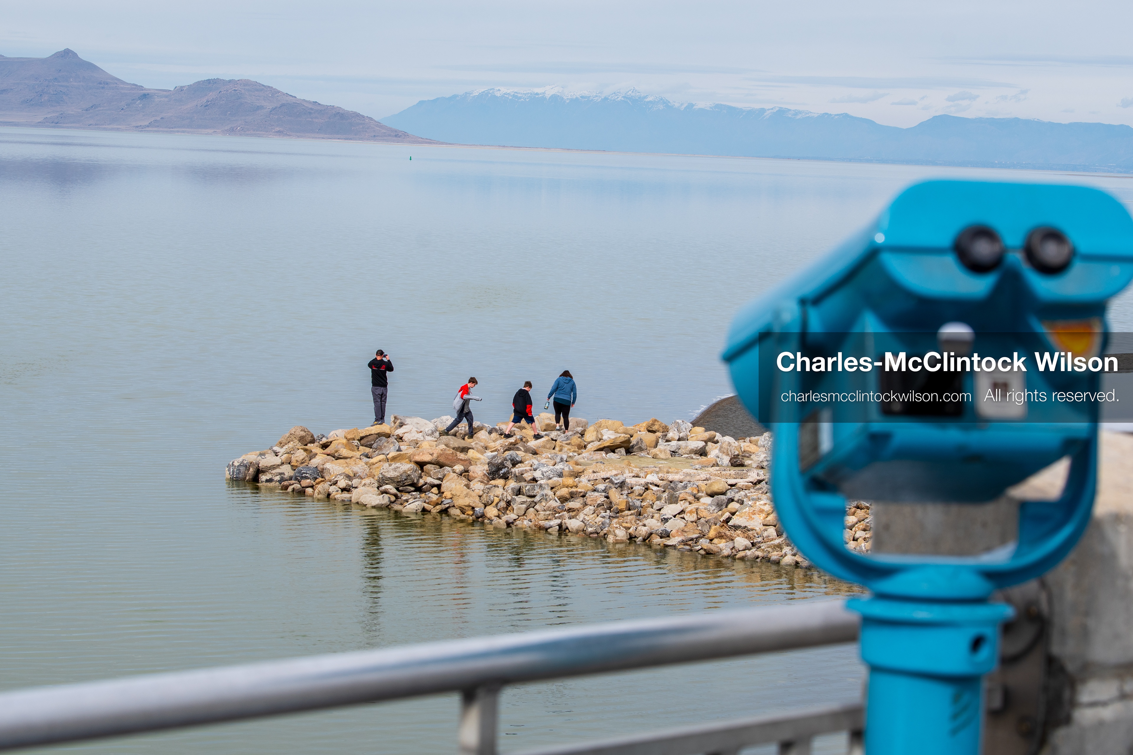 March 1, 2026, Great Salt Lake, Utah, USA: People stand on a rocky outcrop extending into the Great Salt Lake as the region continues to experience historically low water levels. Reports from state officials and the Great Salt Lake Strike Team state that the lake remains in a serious adverse‑effects range, with elevations among the lowest recorded in more than one hundred years. The lake has drawn increased public attention as lawmakers consider large‑scale water projects and long‑term plans to address declining conditions. (Credit Image: © Charles‑McClintock Wilson/ZUMA Press Wire)