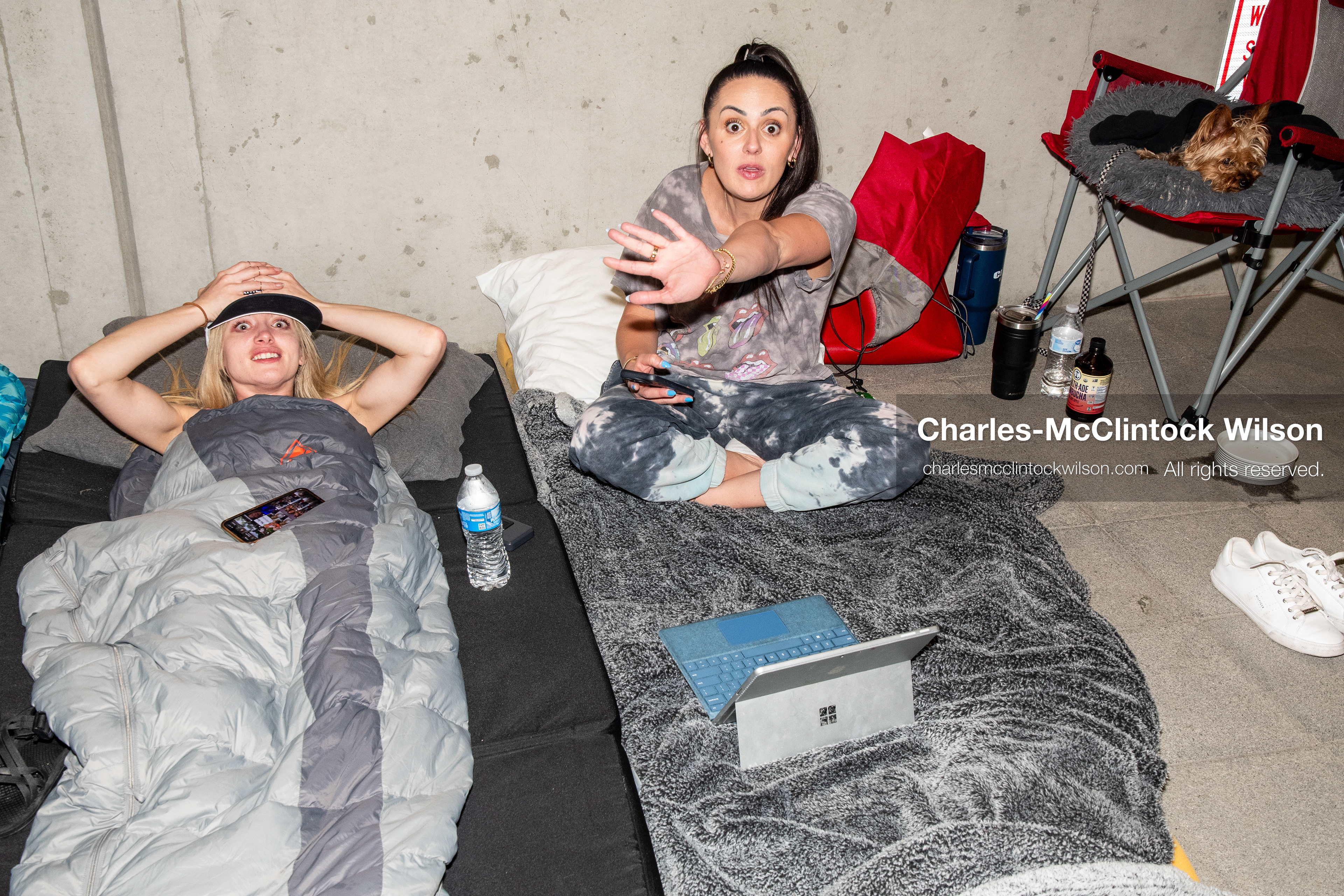 July 10, 2026, Provo, Utah, USA: YouTubers Billie Webb and Brandi Siciliani rest on bedding in the entrance hallway of the Fourth District Court in Provo, Utah, after spending the night there to secure early access for the fifth day of the preliminary hearing in the Tyler Robinson case. Public seating inside the courtroom is limited to 14 people. (Credit Image: © Charles-McClintock Wilson/ZUMA Press Wire)