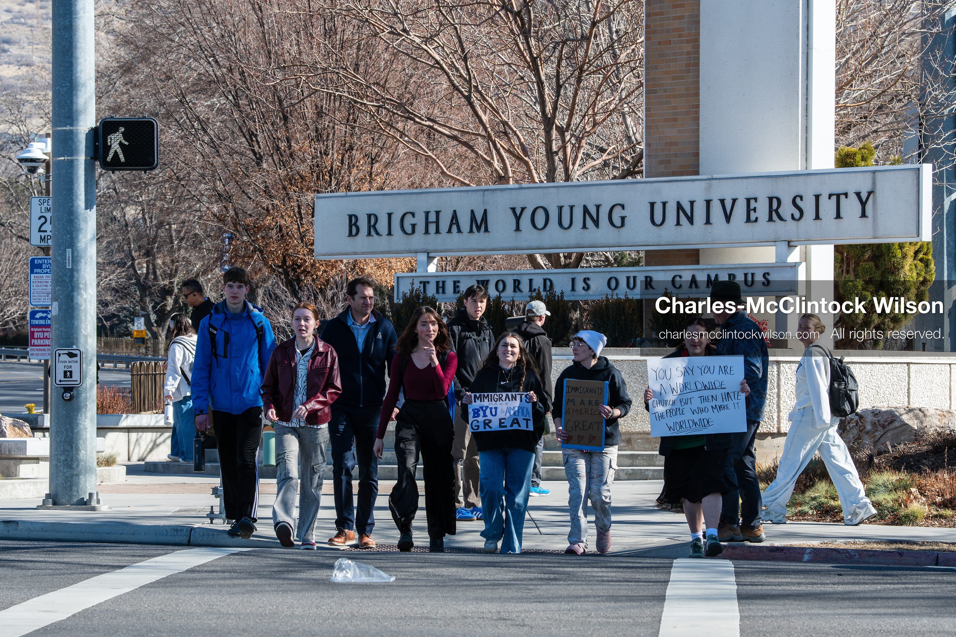 February 5, 2026, Provo, Utah, USA: People walk near the Brigham Young University entrance in Provo as demonstrators carrying signs gather to protest the presence of US Customs and Border Protection recruiters at a career fair held on the BYU campus. (Credit Image: © Charles McClintock Wilson/ZUMA Press Wire)
