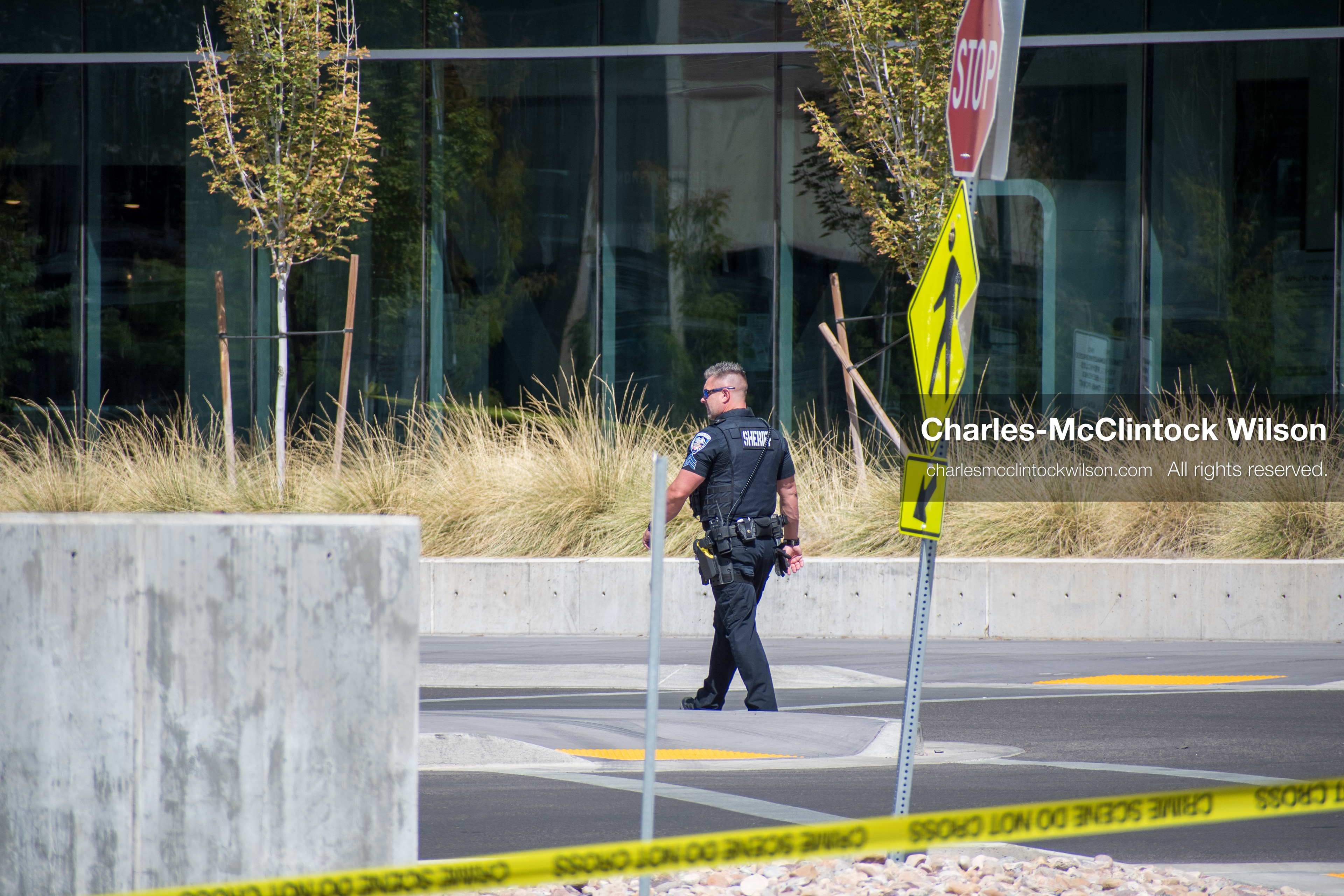September 12, 2025, Orem, Utah, USA: A police officer walks past a cordoned-off area on the campus of Utah Valley University in Orem, Utah, following the assassination of conservative activist CHARLIE KIRK on September 10, 2025. Yellow caution tape surrounds the site where Kirk, CEO of Turning Point USA, was fatally shot while speaking on campus. The scene remains under investigation as law enforcement secures the area and the university confronts the aftermath.   (Credit Image: © Charles‑McClintock Wilson/ZUMA Press Wire)