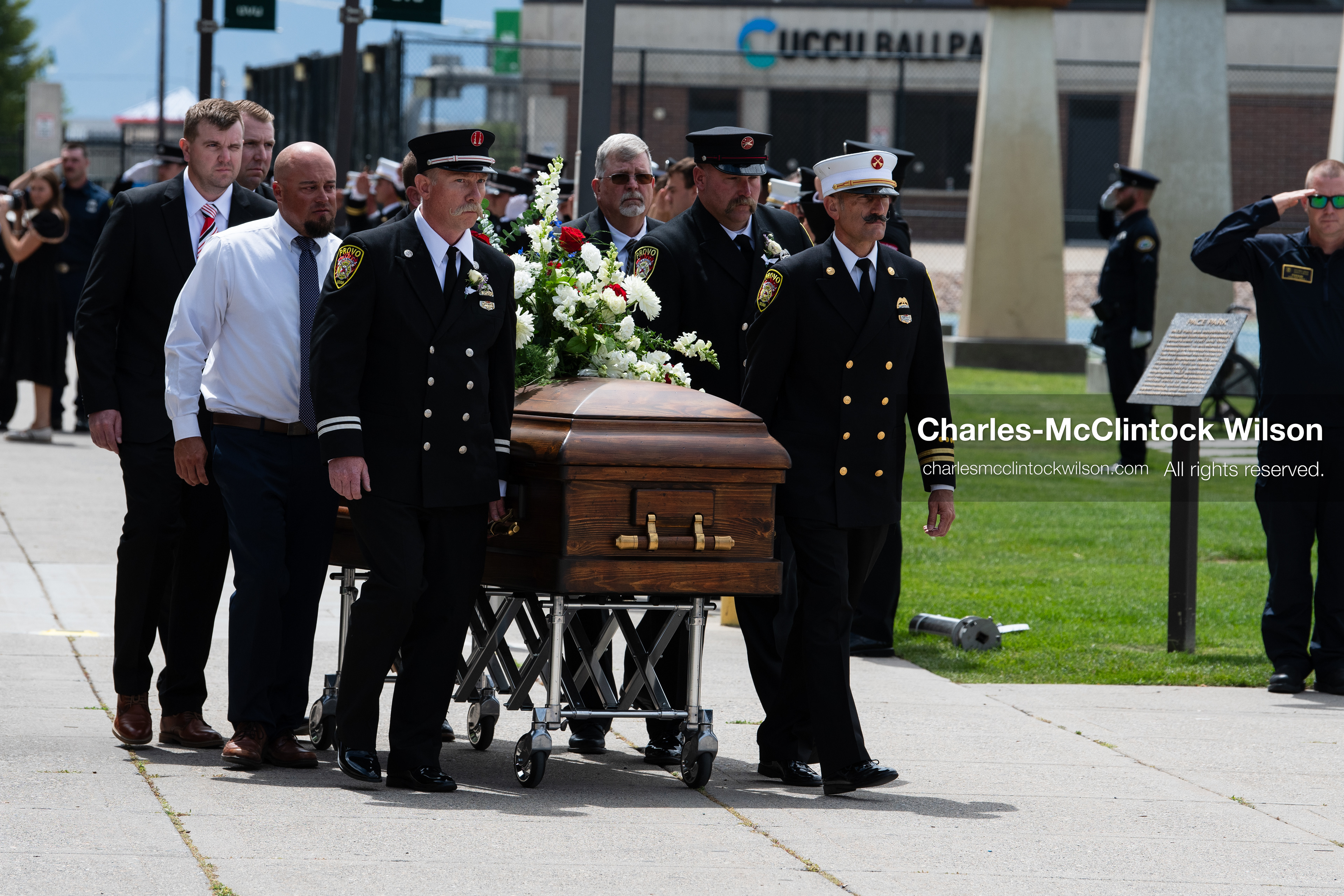 Firefighters and pallbearers escort the casket of Provo Fire Captain Spencer Long outside the UCCU Center on the campus of Utah Valley University in Orem, Utah, on Wednesday, July 29, 2026. More than 300 people came to the public memorial ceremony to honor Captain Long, his wife Katrina, and three of their sons, who died after a flash flood hit their campsite near the Sunglow Campground in Wayne County. (Photo by Charles-McClintock Wilson/Sipa USA)