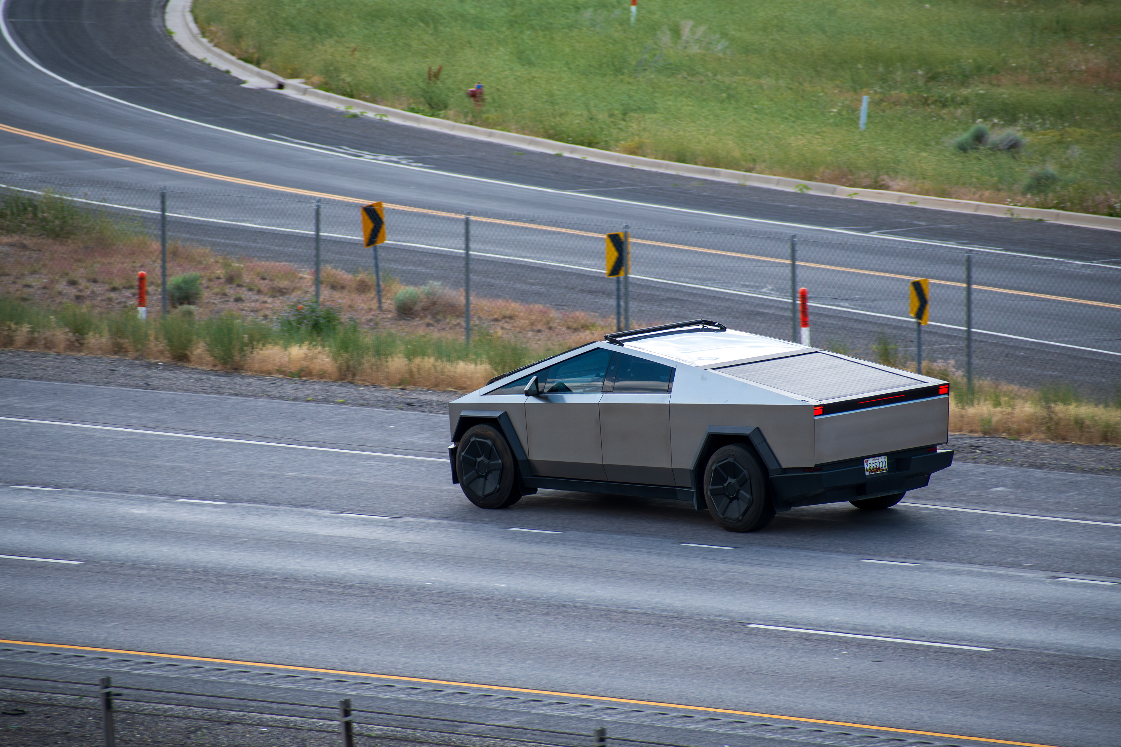 SANTAQUIN, UT – JUNE 8, 2025: A Tesla Cybertruck drives north on Interstate 15 near Santaquin, Utah, on June 8, 2025. The all-electric pickup stands out with its futuristic, angular design.