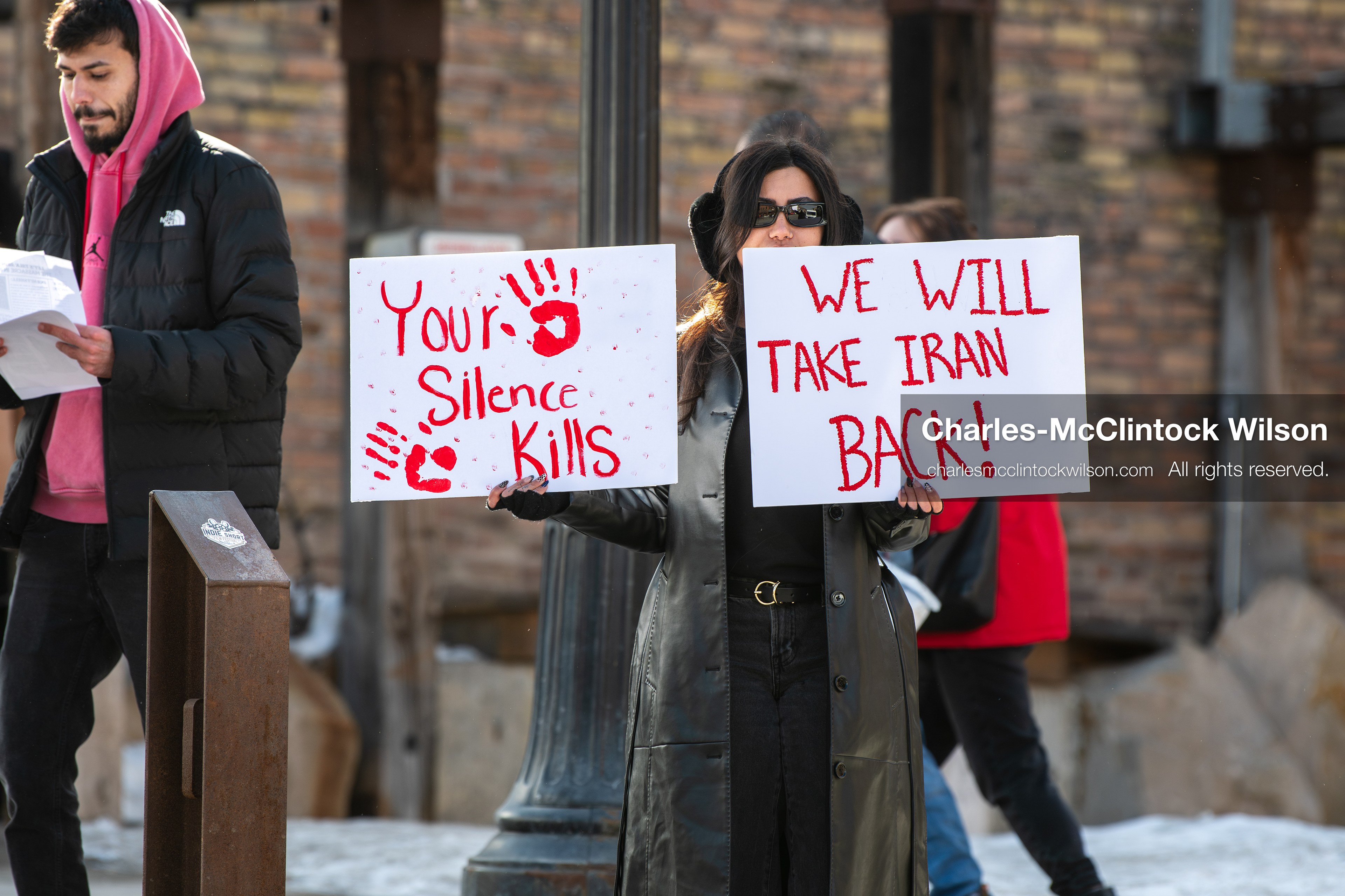 January 30, 2026, Park City, Utah, USA: A demonstrator holds signs during a small protest against the Iranian government on Main Street in Park City, Utah. (Credit Image: © Charles McClintock Wilson/ZUMA Press Wire)