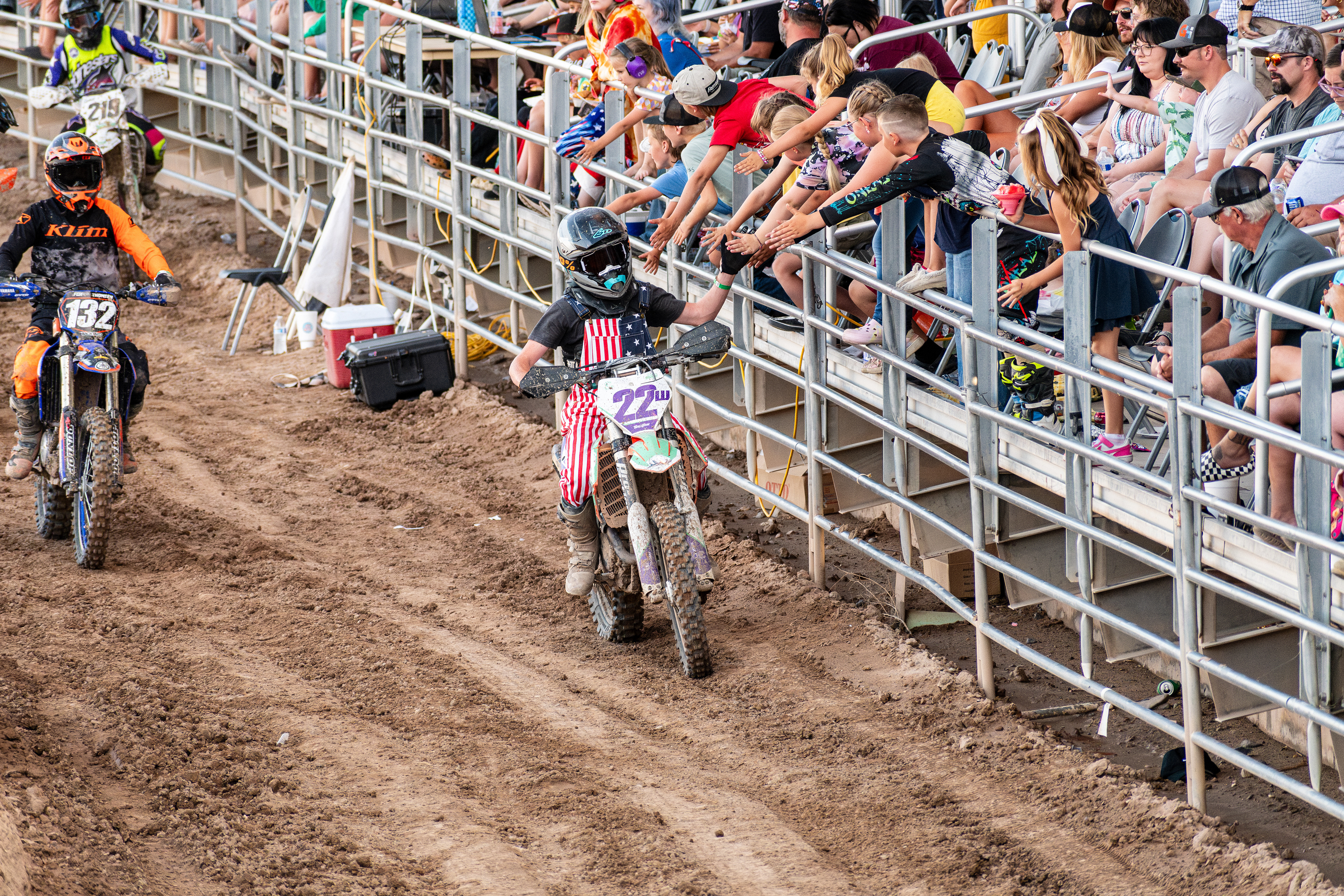 Nephi, Utah – June 28, 2025: Motocross riders greet fans while exiting the arena after competing in the Juab Xtreme Racing event in Nephi, Utah.