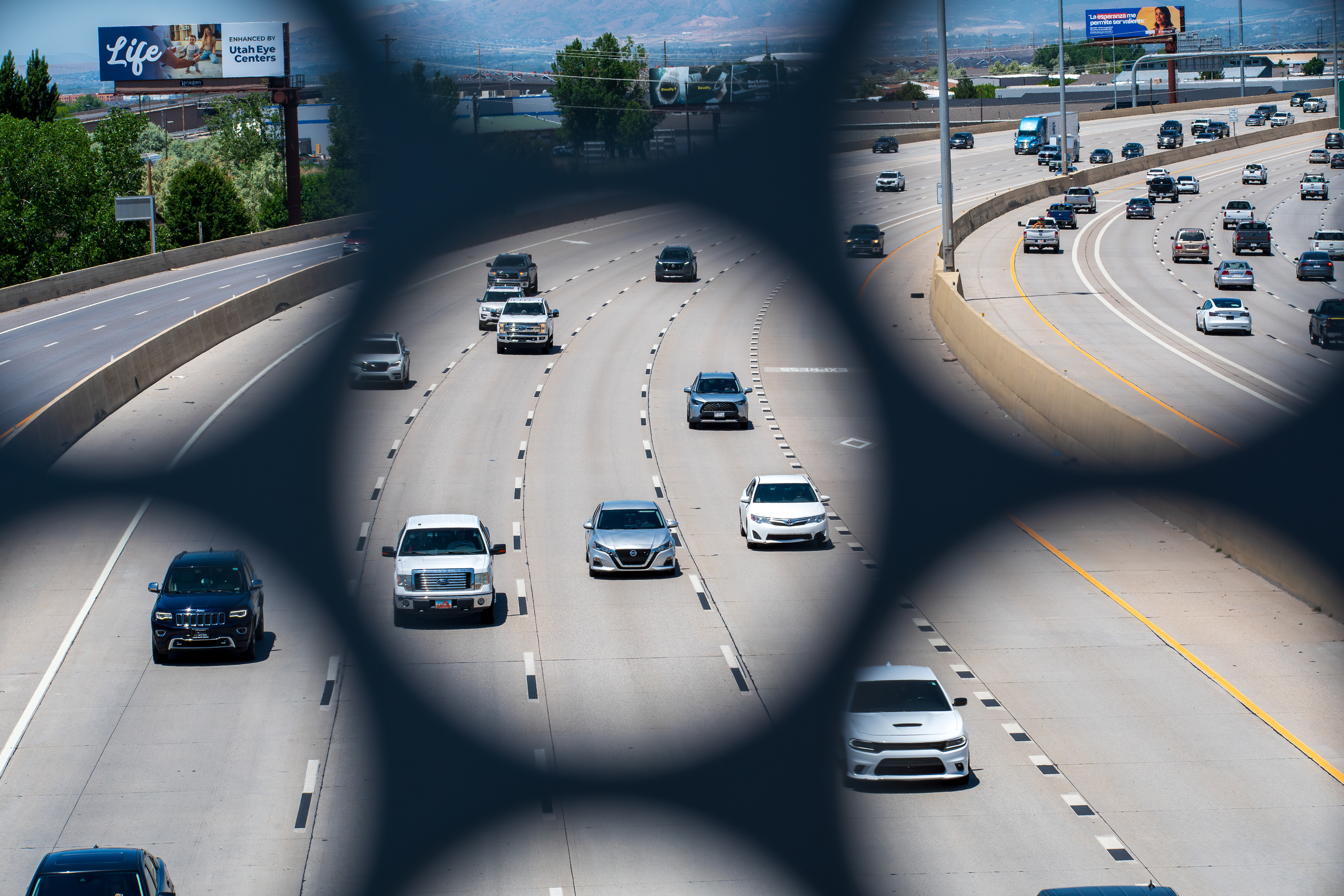 Orem, Utah – June 2, 2025: Northbound traffic moves along Interstate 15 as seen through a structural opening in the UVU Pedestrian Bridge in Orem, Utah.