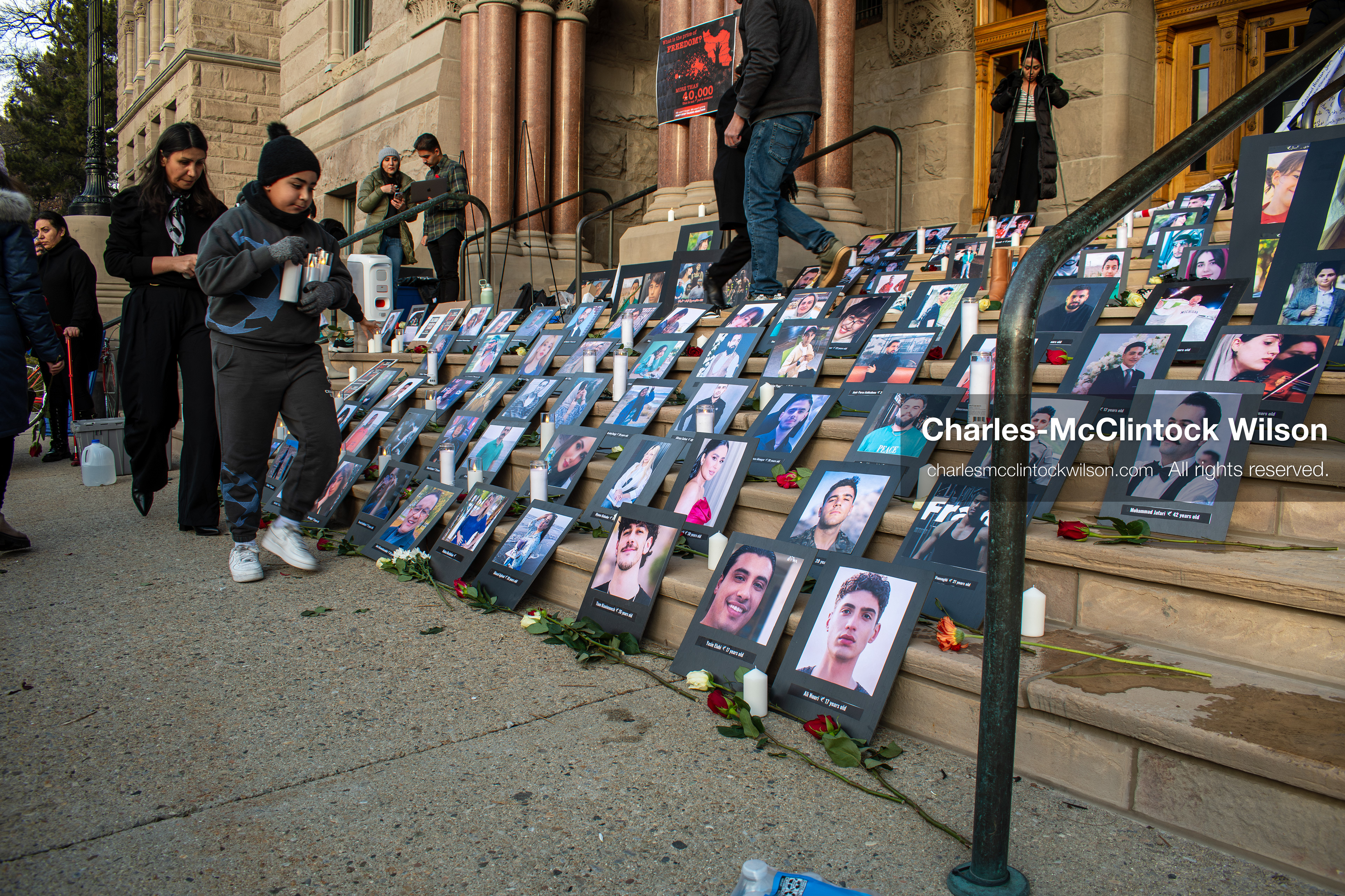 January 30, 2026, Salt Lake City, Utah, USA: People gather around portraits, candles, and flowers arranged on the steps of the Salt Lake City and County Building during a vigil honoring victims of the Iranian government. (Credit Image: © Charles McClintock Wilson/ZUMA Press Wire)