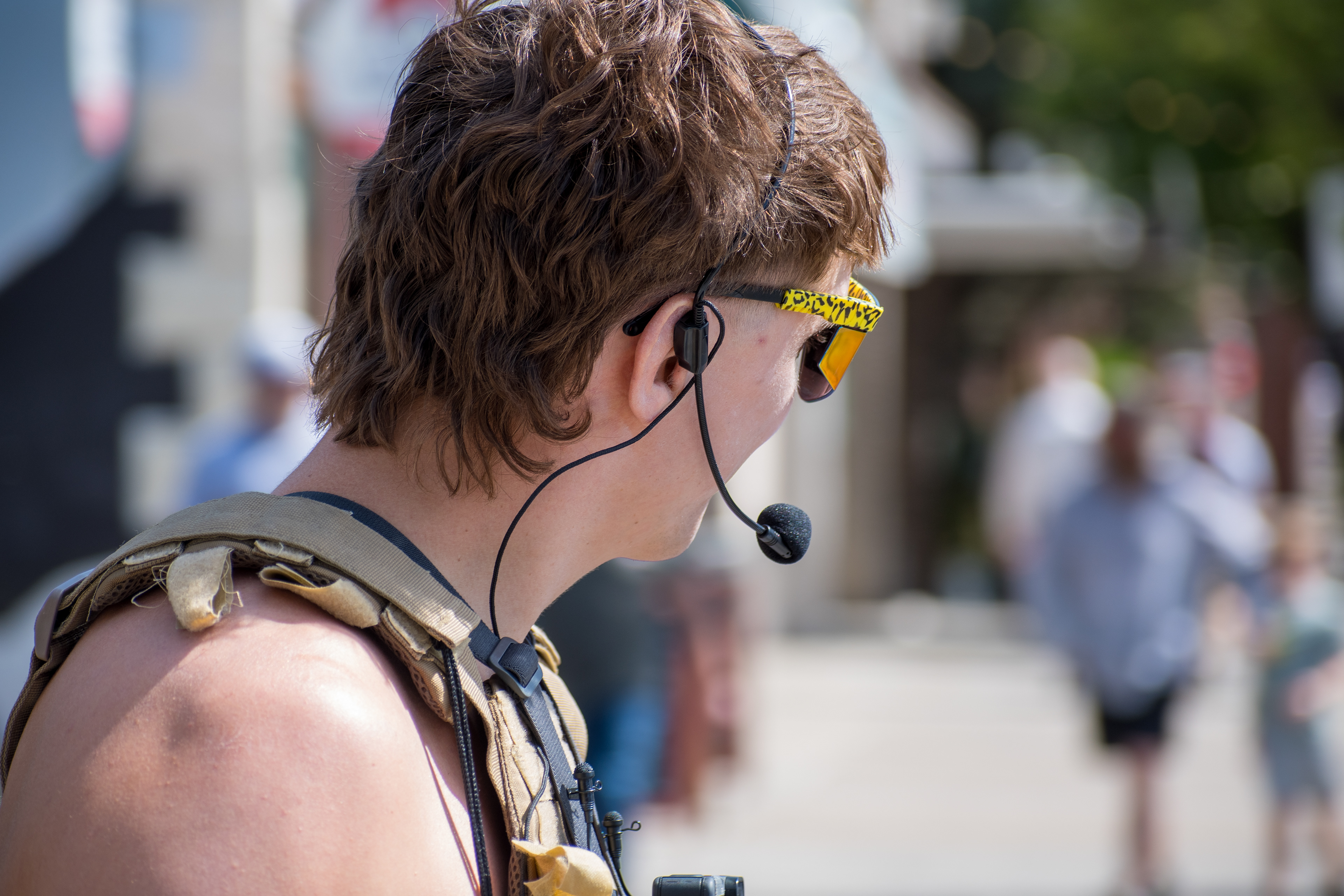 September 15, 2025 – Provo, Utah, United States: A demonstrator speaks emphatically into a headset microphone outside the Utah Valley Convention Center during a protest against the Department of Homeland Security career expo. Reflective “Pit Viper” sunglasses and a mullet hairstyle add visual intensity to the moment of civic expression. Photograph by Charles‑McClintock Wilson / ZUMA Press Wire