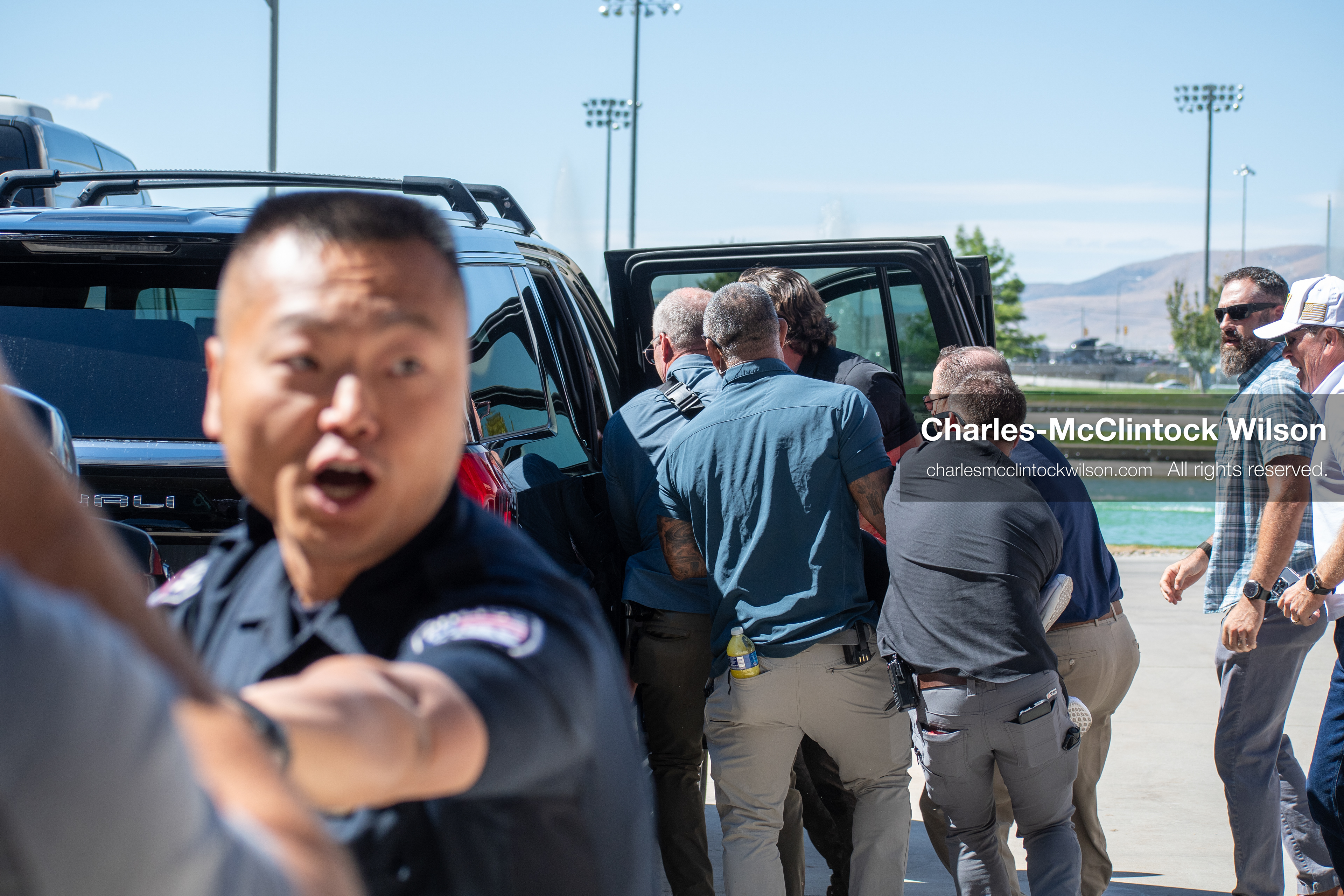 September 10, 2025, Orem, Utah, USA: Law enforcement and security personnel coordinate the evacuation of conservative activist Charlie Kirk following a shooting during a public event at Utah Valley University. Kirk is transported to the hospital as emergency protocols unfold. He died from his injuries a few hours later. Officers secure the vehicle and manage crowd control amid a multi-agency response. (Credit Image: © Charles-McClintock Wilson/ZUMA Press Wire)