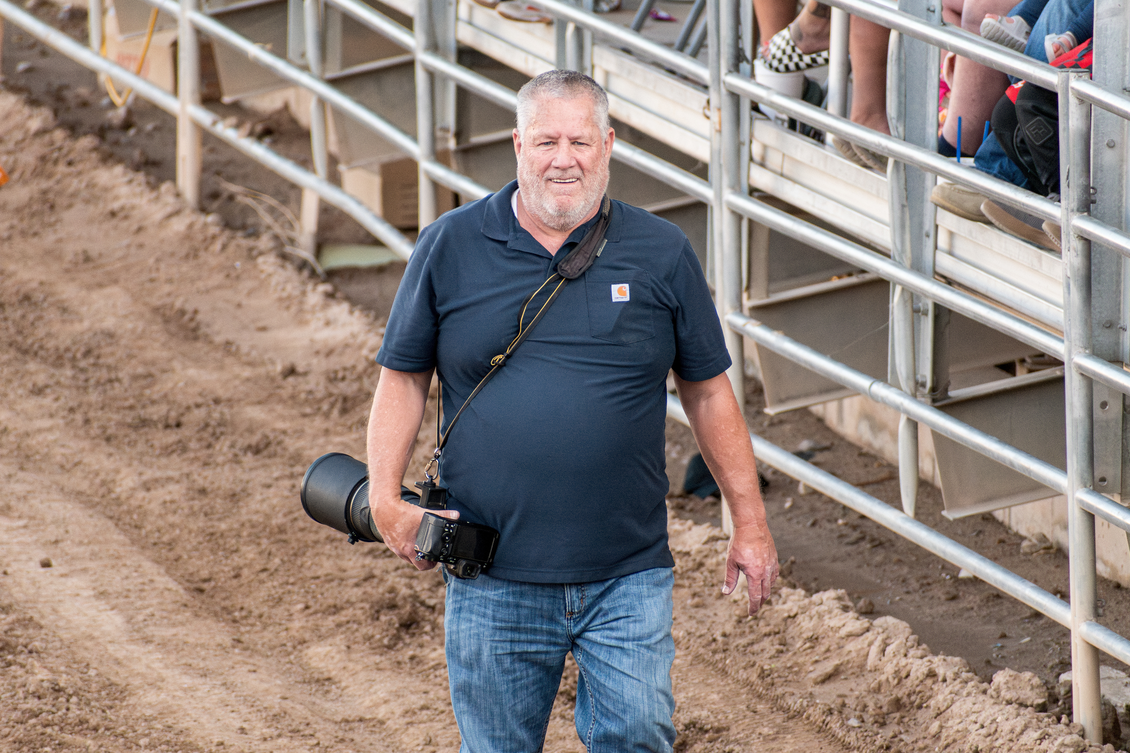June 28, 2025 – Nephi, Utah: A photographer takes photos of motocross riders from the edge of the dirt arena during the Juab Xtreme Racing event.