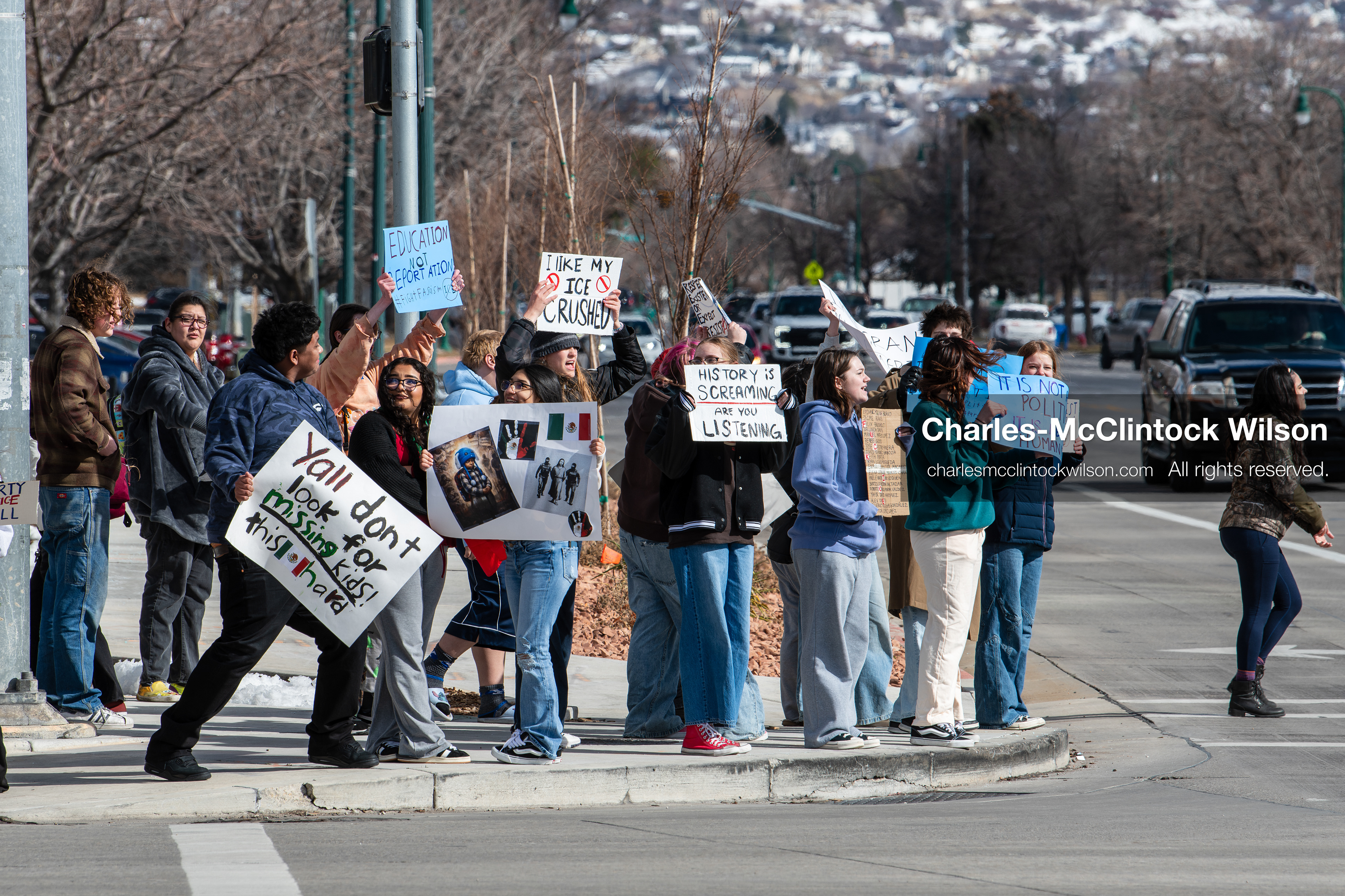 February 20, 2026, Orem, Utah, USA: High school students gather along State Street in front of Orem City Hall during a student led protest against ICE and federal immigration enforcement. Demonstrators hold signs as they stand near the roadway while traffic continues through the area. (Credit Image: © Charles McClintock Wilson/ZUMA Press Wire)