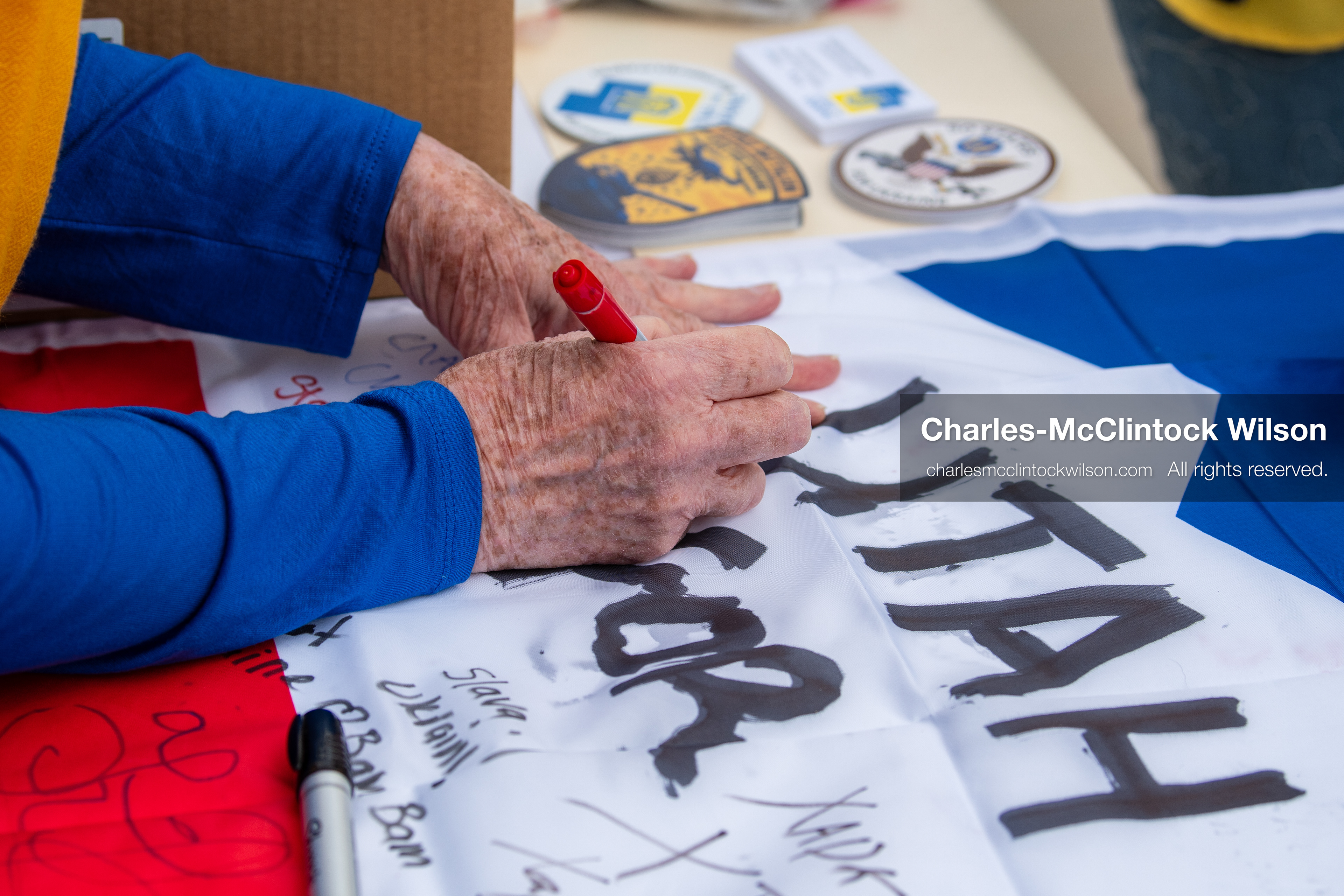 February 28, 2026, Salt Lake City, Utah, USA: A participant adds a message to a flag at a table near the Utah State Capitol during the Stand With Ukraine rally. The gathering marked the four year anniversary of the full scale Russian invasion of Ukraine and brought community members together in support of Ukrainians and local humanitarian efforts. (Credit Image: © Charles McClintock Wilson/ZUMA Press Wire)