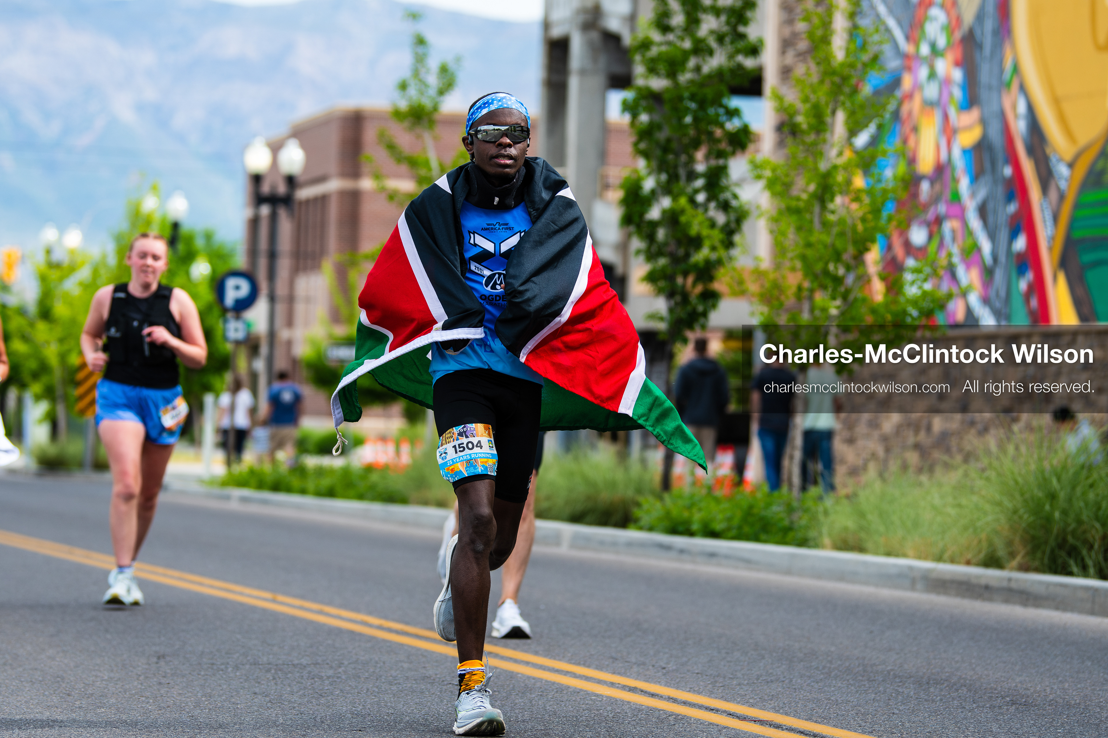May 16, 2026, Ogden, Utah, USA: A runner draped in the Kenyan flag competes in the 25th Annual America First Ogden Marathon in Ogden, Utah, on Saturday, May 16, 2026. The event drew thousands of participants and spectators for the milestone 25th running of the marathon. (Credit Image: © Charles-McClintock Wilson/ZUMA Press Wire)