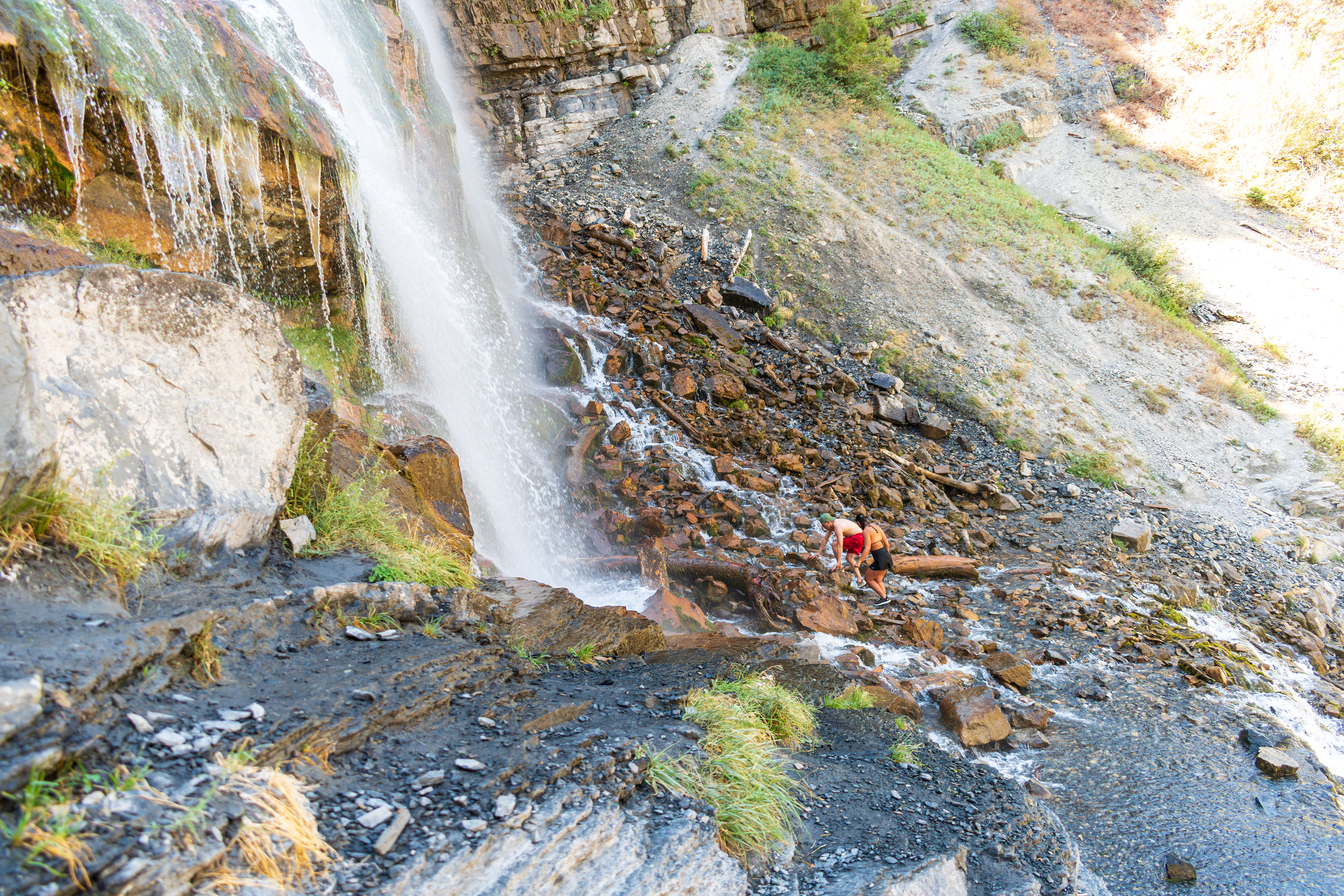 Provo, Utah, USA — September 1, 2025: Visitors gather at the base of Bridal Veil Falls as multiple streams of water cascade down the steep rock face.