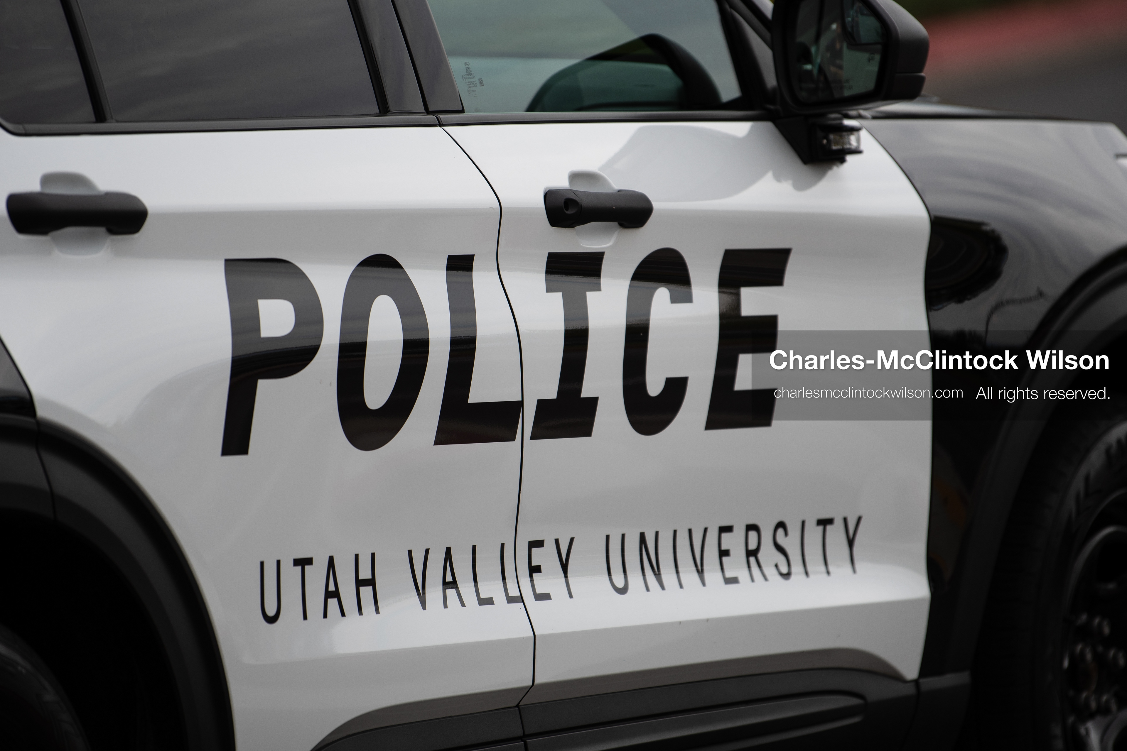 A close-up shot shows the side door of a Utah Valley University Police cruiser parked outside the UCCU Center in Orem, Utah, on Wednesday, July 29, 2026. More than 300 people came to the public memorial ceremony to honor Provo Fire Captain Spencer Long, his wife Katrina, and three of their sons, who died after a flash flood hit their campsite near the Sunglow Campground in Wayne County. (Photo by Charles-McClintock Wilson/Sipa USA)