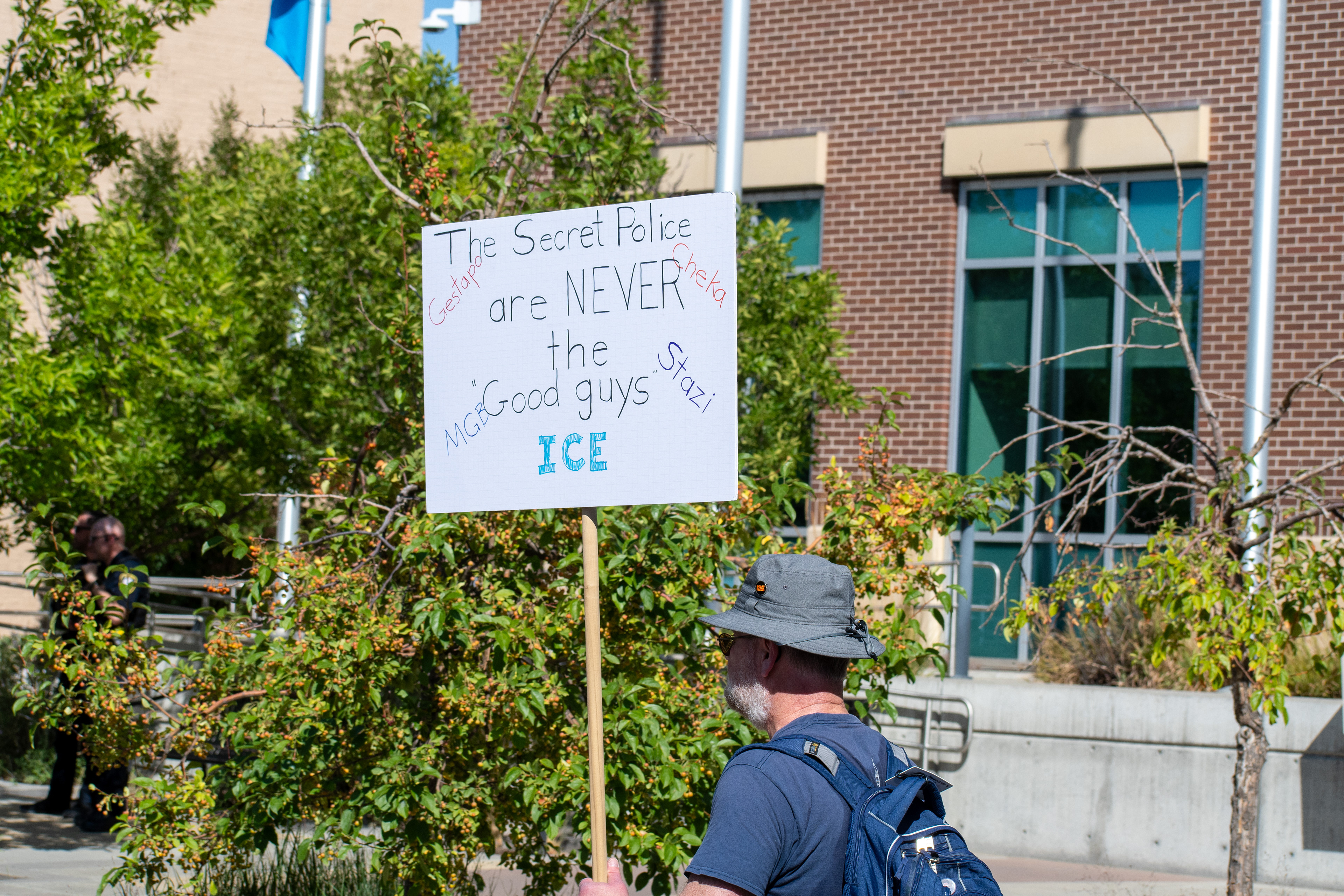 September 15, 2025 – Provo, Utah, United States: A demonstrator holds a sign comparing ICE to historical secret police organizations—including the Gestapo, Cheka, MGB, and Stasi—outside the Utah Valley Convention Center during a protest against the Department of Homeland Security career expo. The message asserts that “The Secret Police are NEVER the Good guys,” invoking historical critique and symbolic resistance. Photograph by Charles‑McClintock Wilson / ZUMA Press Wire