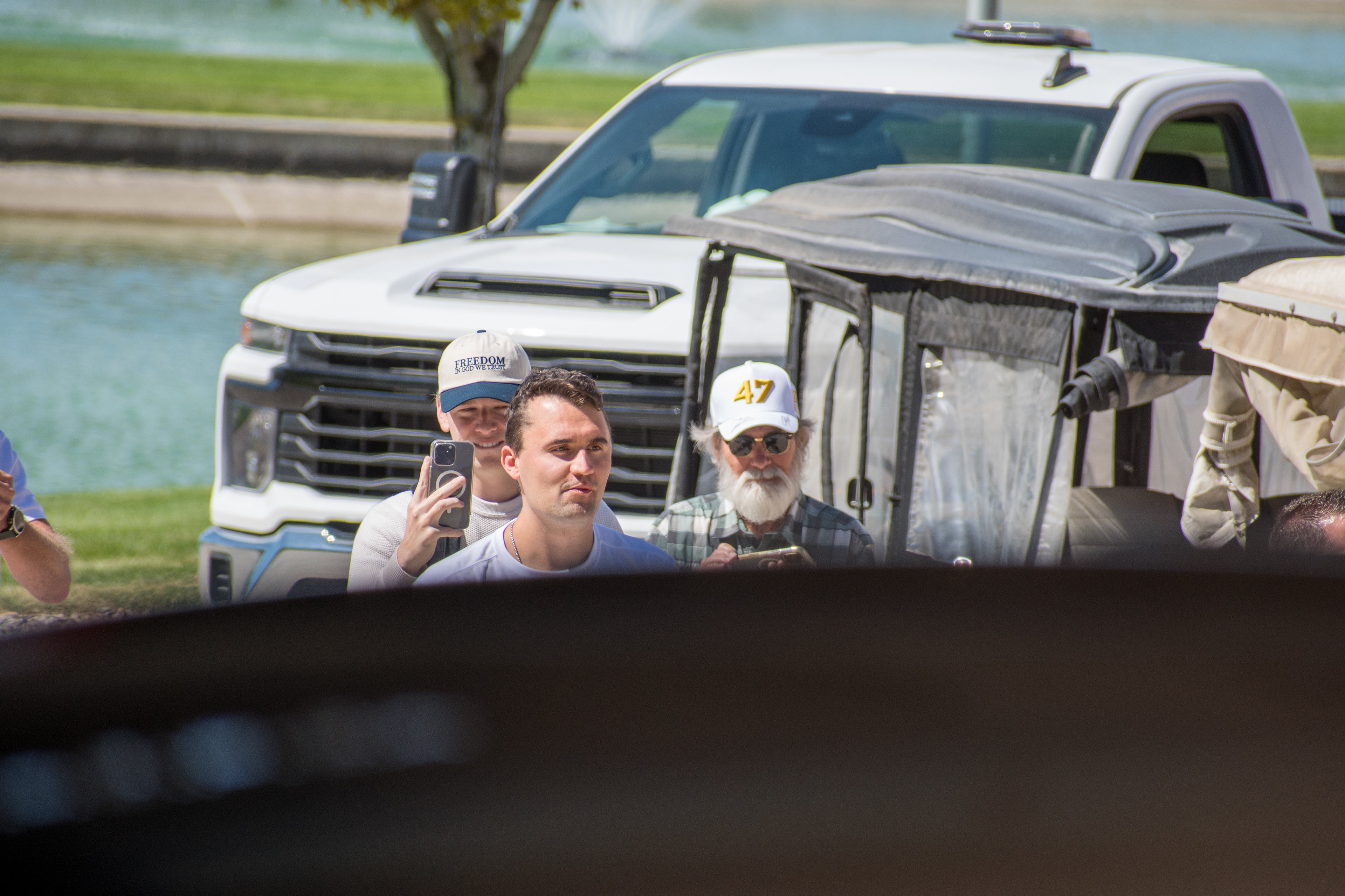 OREM, UTAH – SEPTEMBER 10, 2025: Charlie Kirk gestures while arriving at Utah Valley University for a scheduled public event. Surrounded by supporters and staff near a park-like setting, Kirk points toward the crowd in a moment of expressive engagement. The image marks the beginning of his final public appearance, reflecting anticipation, outreach, and symbolic presence. © Charles-McClintock Wilson / ZUMA Press 