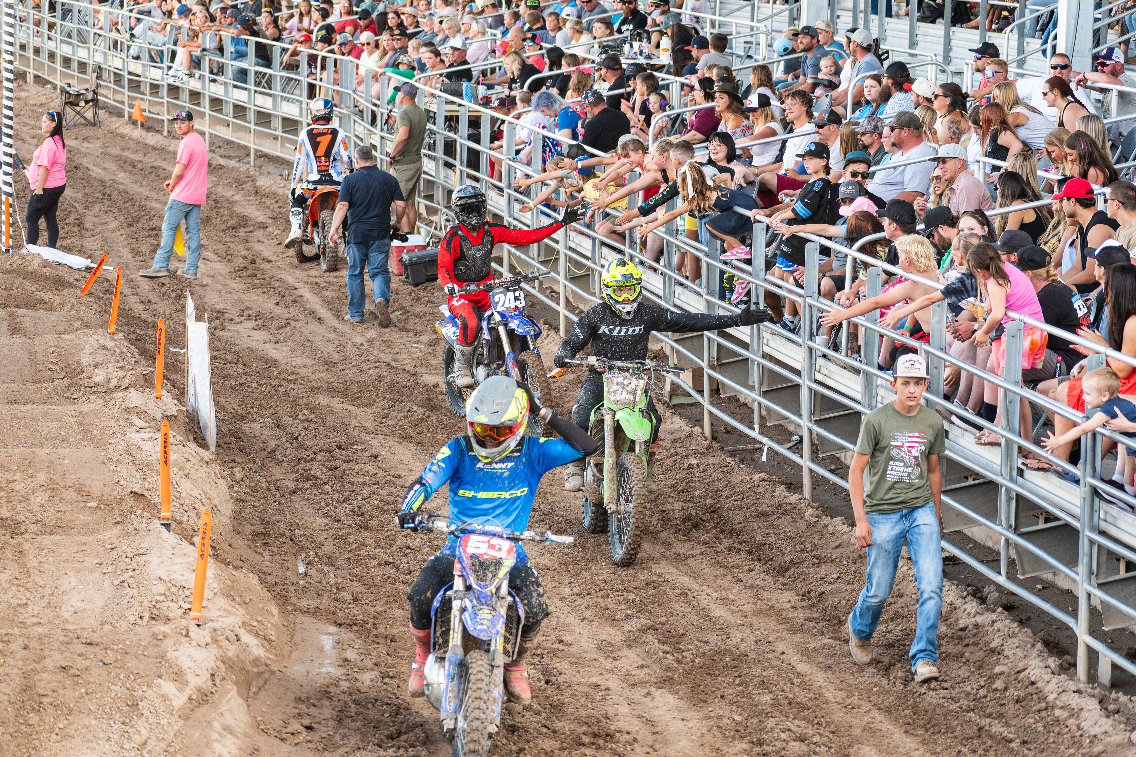 Nephi, Utah – June 28, 2025: Motocross riders greet fans while exiting the arena after competing in the Juab Xtreme Racing event in Nephi, Utah.