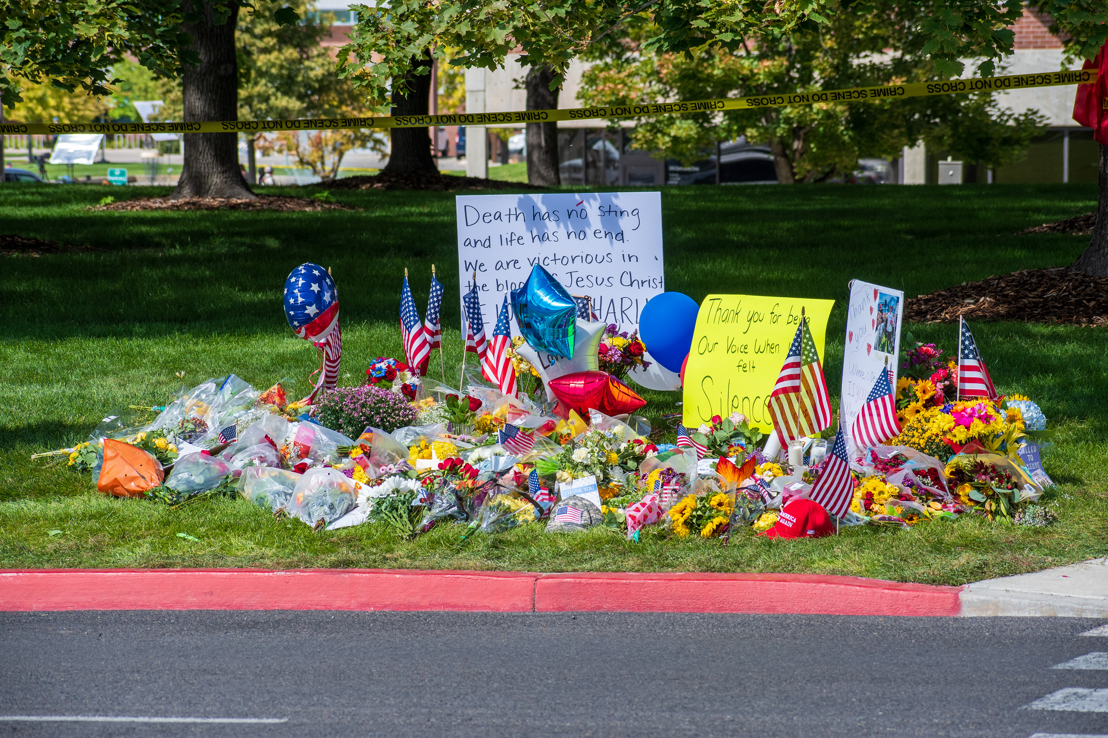 OREM, UTAH – SEPTEMBER 12, 2025: Flowers, American flags, balloons, and handwritten posters are arranged on a grassy memorial site for Charlie Kirk near Utah Valley University. The tribute reflects a collective expression of remembrance and community solidarity. © Charles‑McClintock Wilson / ZUMA Press