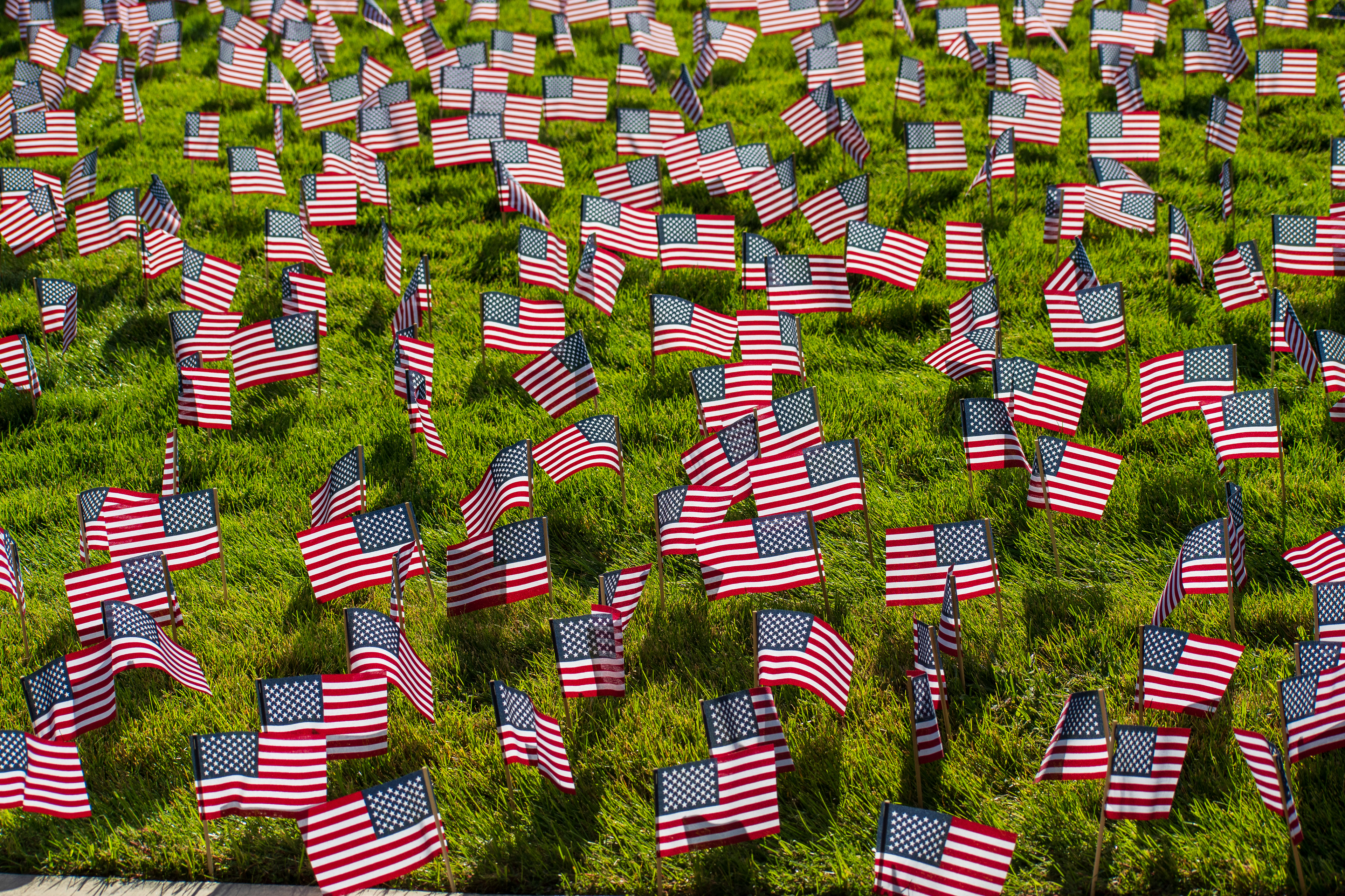OREM, UTAH – SEPTEMBER 10, 2025: Hundreds of small American flags are planted in formation across the lawn at Utah Valley University during the opening stop of the American Comeback Tour. The installation reflects a moment of visual solemnity, symbolic presence, and commemorative clarity. The image captures the spatial rhythm and emotional resonance of a public gathering shaped by remembrance and civic engagement. © Charles-McClintock Wilson / ZUMA Press