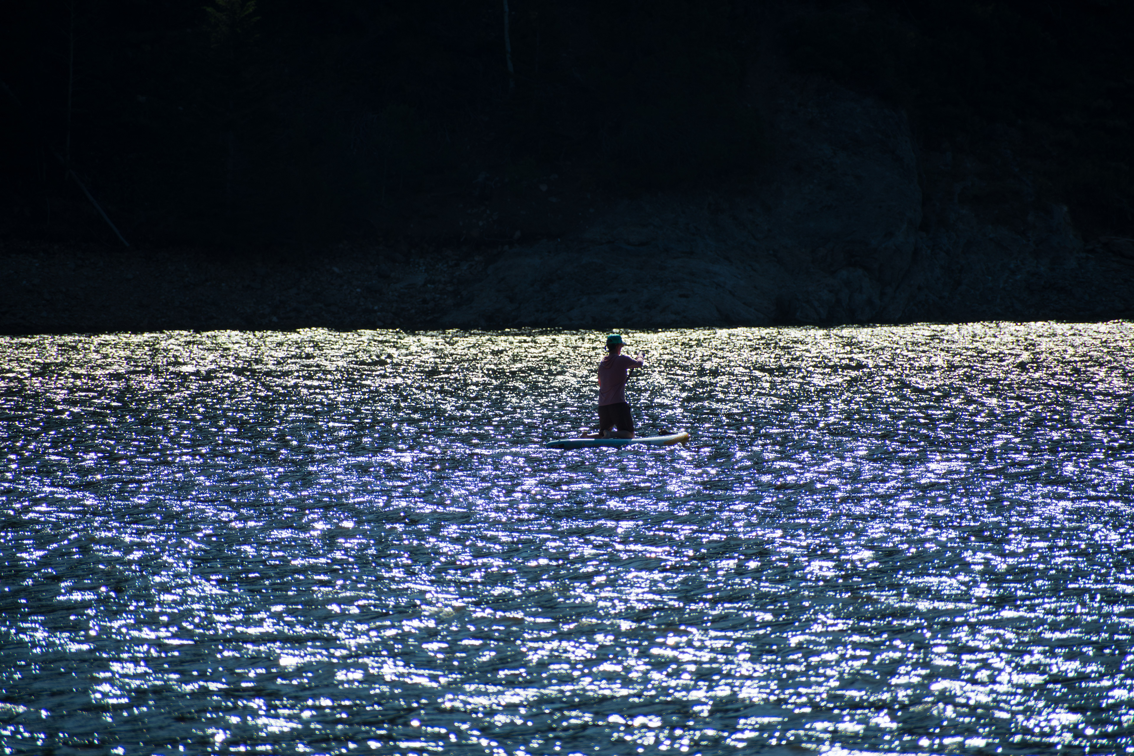 Summit County, Utah – July 20, 2025: A man paddleboards across the water at Smith and Morehouse Reservoir. 
