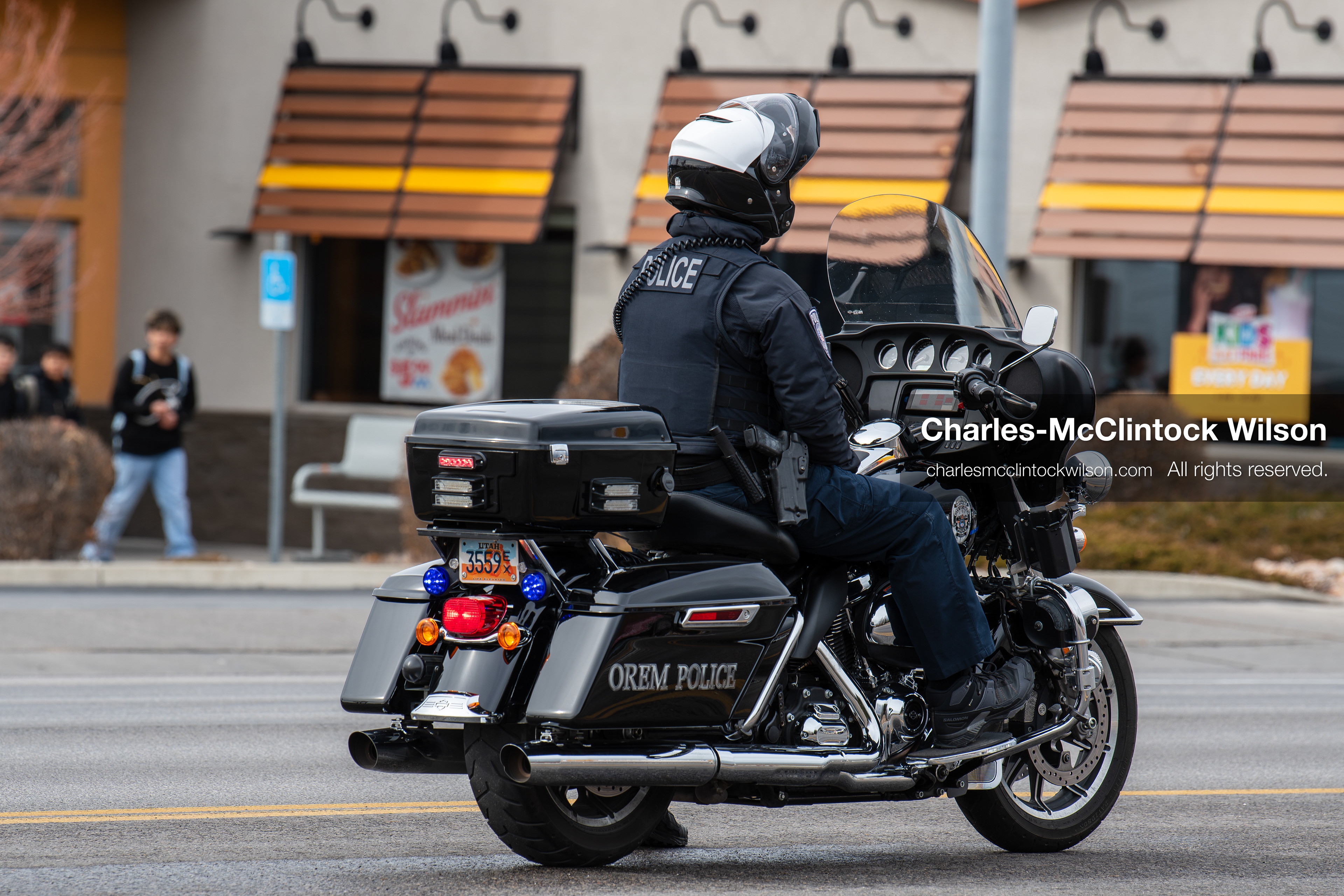 February 11, 2026, Orem, Utah, USA: An Orem police officer rides a motorcycle near State Street during an anti‑ICE protest involving students from multiple Orem schools. (Credit Image: © Charles‑McClintock Wilson/ZUMA Press Wire)