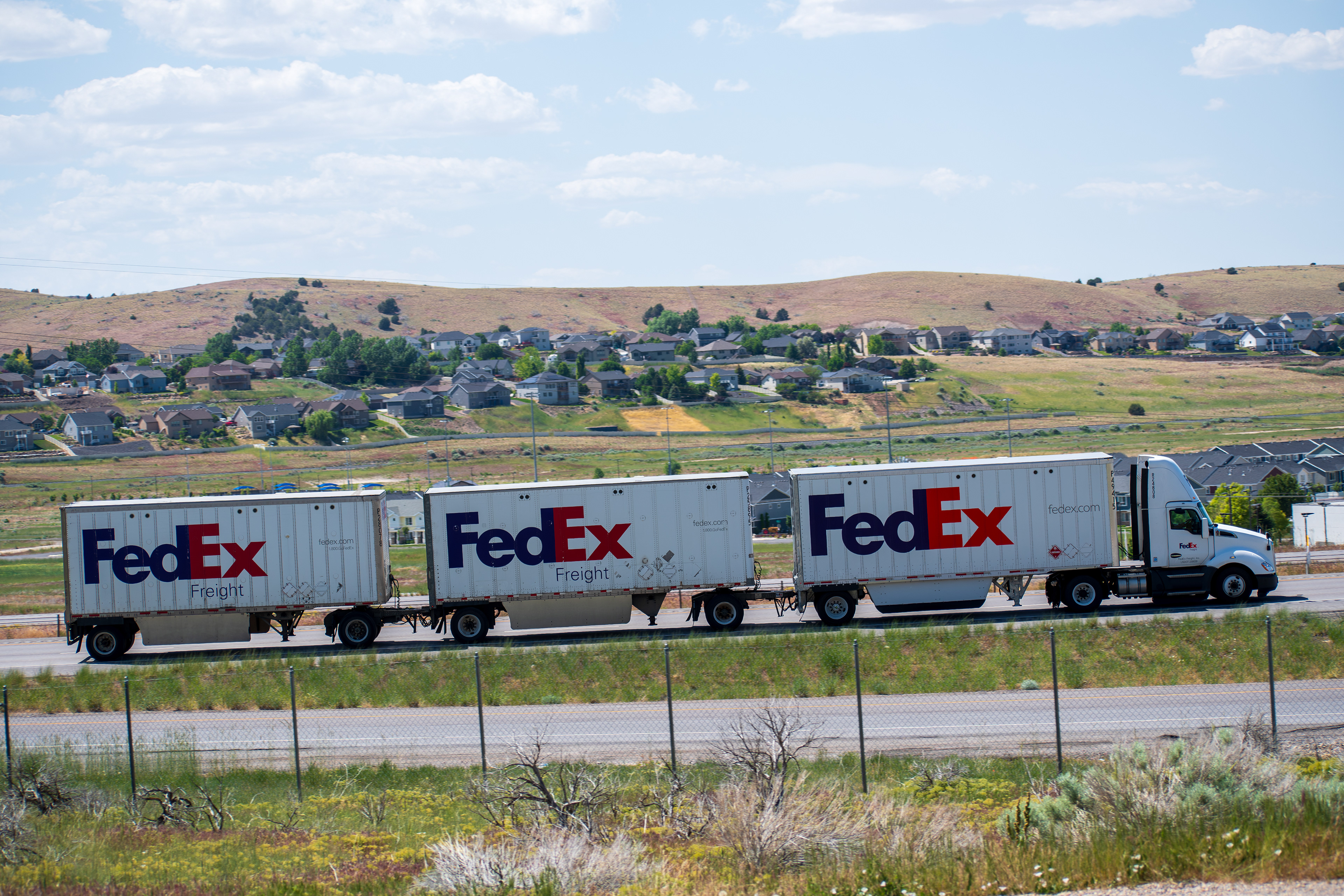 Santaquin, Utah – June 2, 2025: A FedEx truck with three trailers drives northbound on Interstate 15 in Santaquin, Utah, United States.