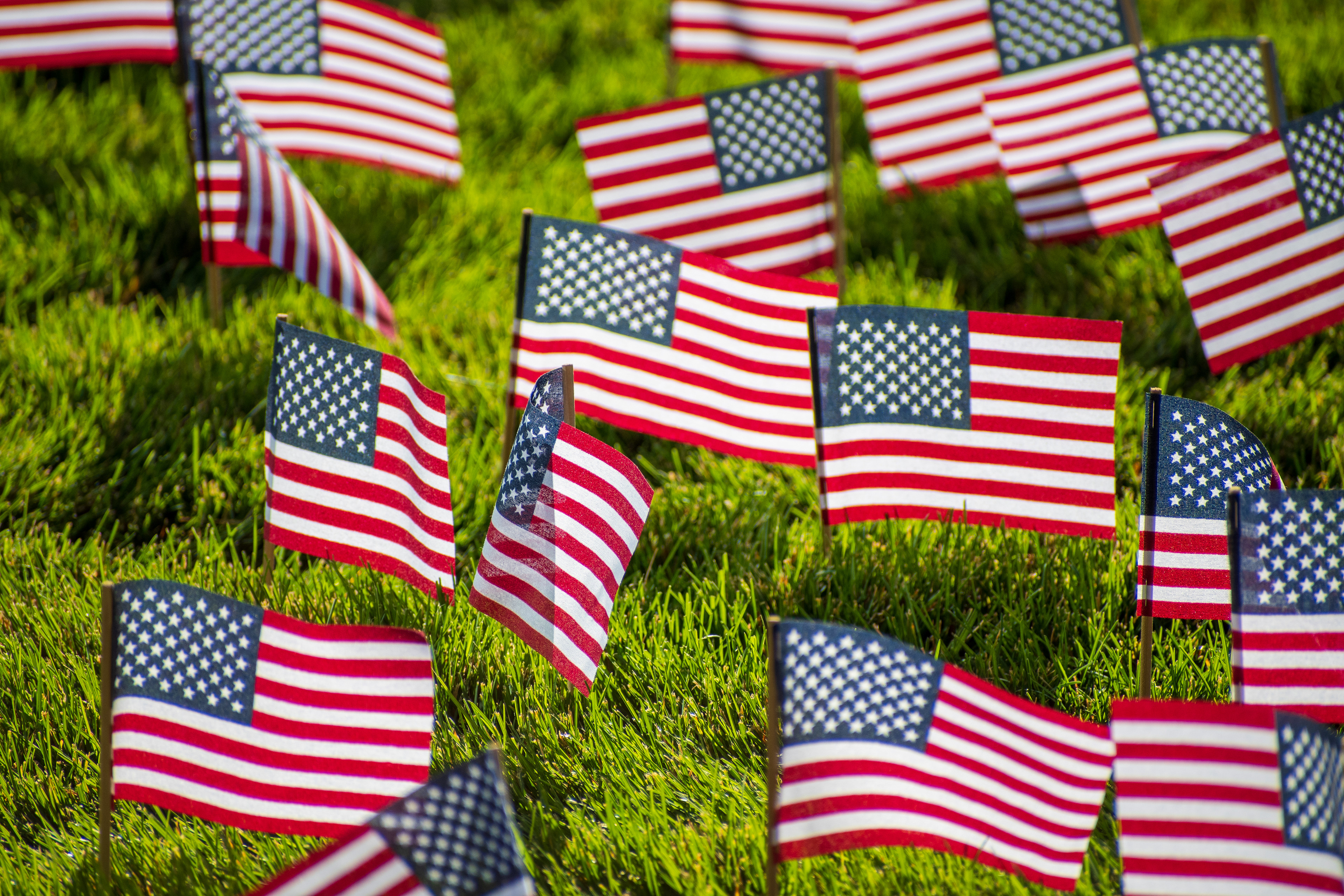 OREM, UTAH – SEPTEMBER 10, 2025: Hundreds of small American flags are planted in formation across the lawn at Utah Valley University during the opening stop of the American Comeback Tour. The installation reflects a moment of visual solemnity, symbolic presence, and commemorative clarity. The image captures the spatial rhythm and emotional resonance of a public gathering shaped by remembrance and civic engagement. © Charles-McClintock Wilson / ZUMA Press