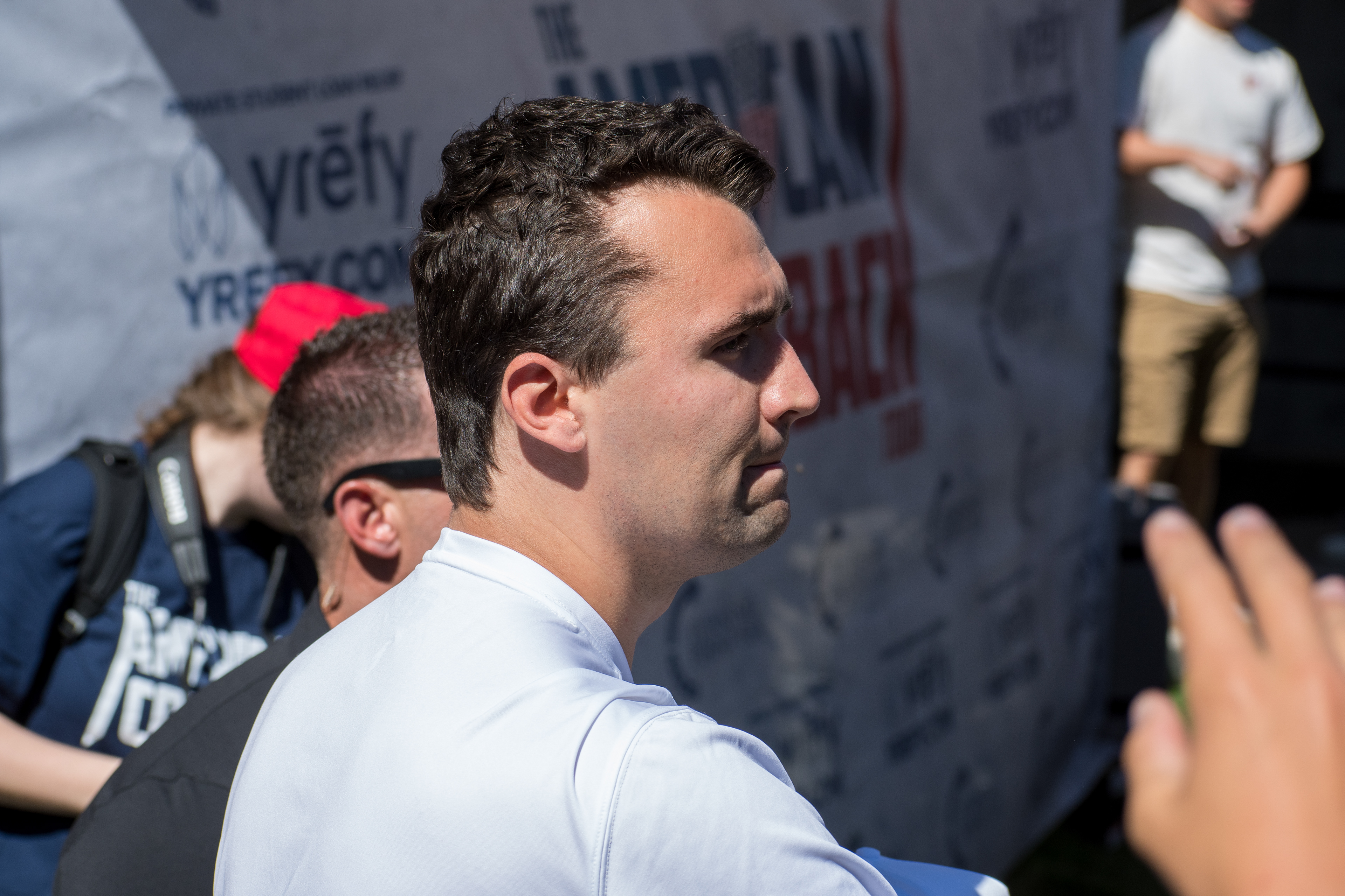 OREM, UTAH – SEPTEMBER 10, 2025: Charlie Kirk holds several “Make America Great Again” hats while interacting with supporters during a public event at Utah Valley University. Positioned near a merchandise table and surrounded by attendees, Kirk engages directly with the crowd in one of his final public moments. The image reflects the branding, outreach, and political symbolism that defined the gathering. © Charles-McClintock Wilson / ZUMA Press