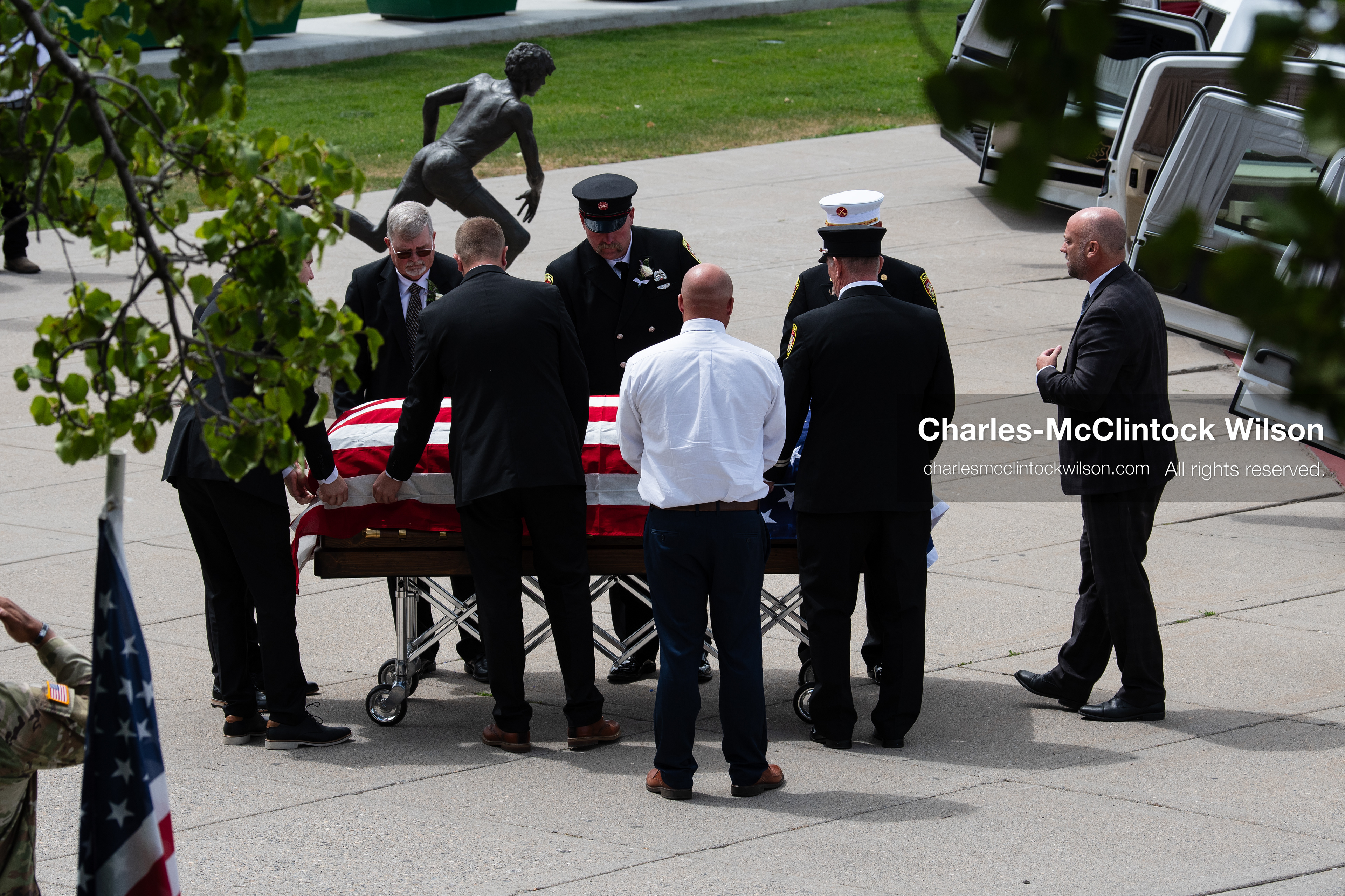 Firefighters and pallbearers load the flag-draped casket of Provo Fire Captain Spencer Long into a white hearse outside the UCCU Center at Utah Valley University in Orem, Utah, on Wednesday, July 29, 2026. More than 300 people came to the public memorial ceremony to honor Captain Long, his wife Katrina, and three of their sons, who died after a flash flood hit their campsite near the Sunglow Campground in Wayne County. (Photo by Charles-McClintock Wilson/Sipa USA)