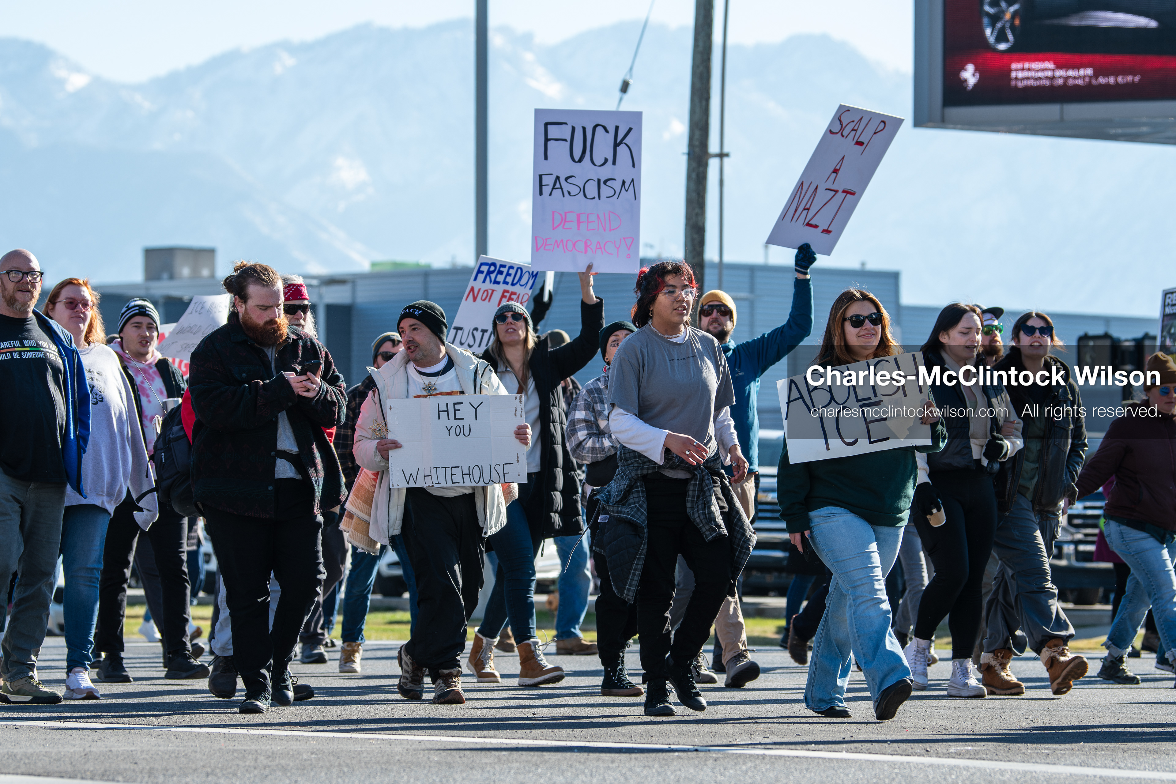 Salt Lake City, Utah, January 10, 2026: A group of demonstrators marches through downtown Salt Lake City during the ICE Out for Good protest, which began at Washington Square Park, with participants carrying signs and personal items as they walk together. (Credit Image: © Charles‑McClintock Wilson/ZUMA Press Wire)