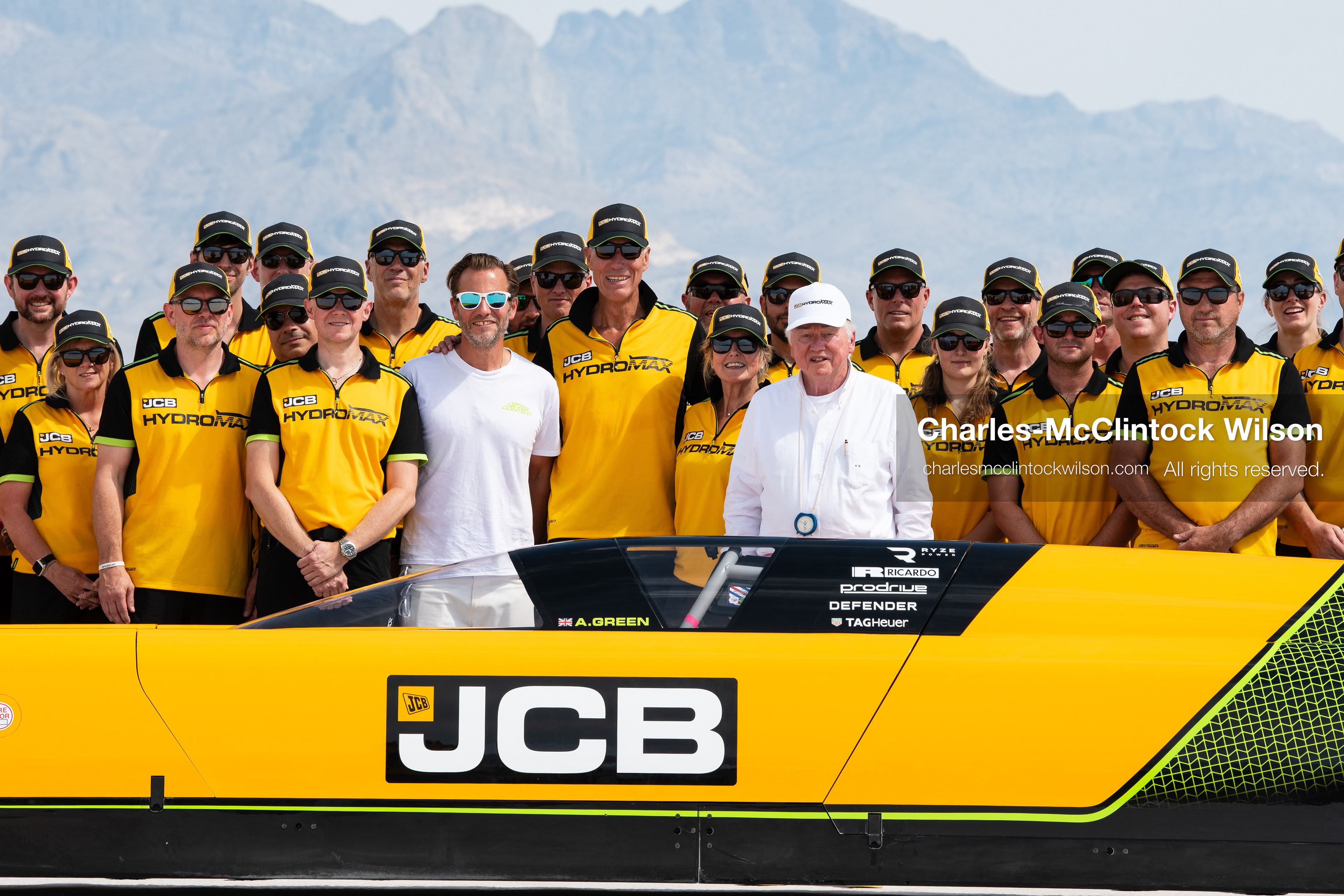 August 11, 2026, Wendover, Utah, USA: British pilot Andy Green and JCB Chairman Anthony Bamford stand with members of the JCB engineering team behind the ''JCB Hydromax'' on the Bonneville Salt Flats on Tuesday. The team gathered to celebrate setting a new hydrogen land speed record of 406.320 mph. (Credit Image: © Charles McClintock Wilson/ZUMA Press Wire)