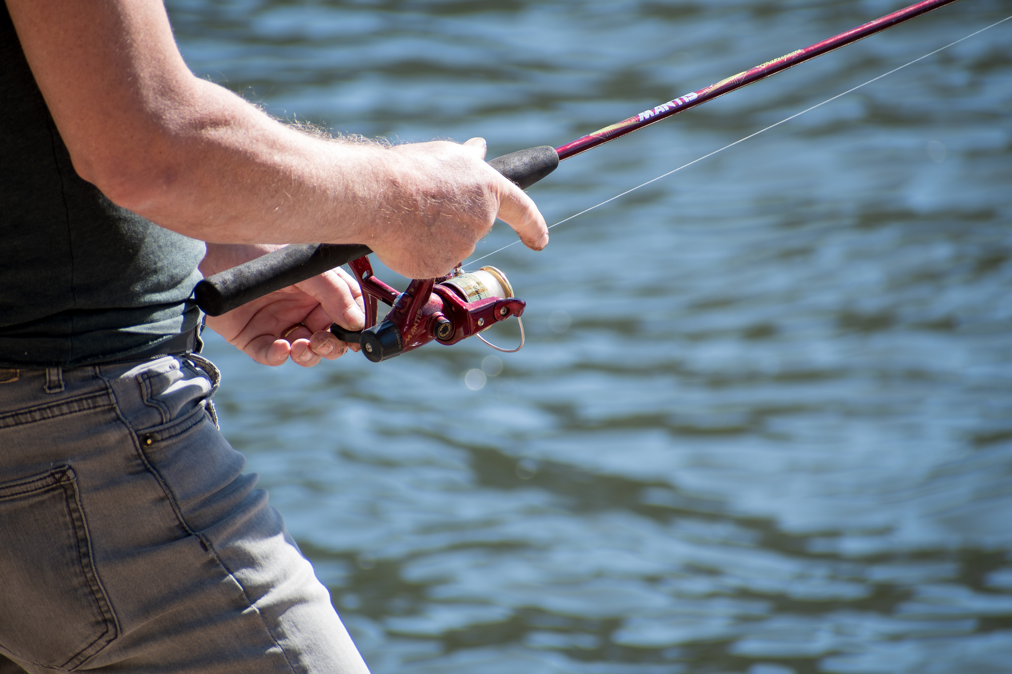 Summit County, Utah – July 20, 2025: A man fishes alone on the calm waters of Smith and Morehouse Reservoir during a quiet summer day.