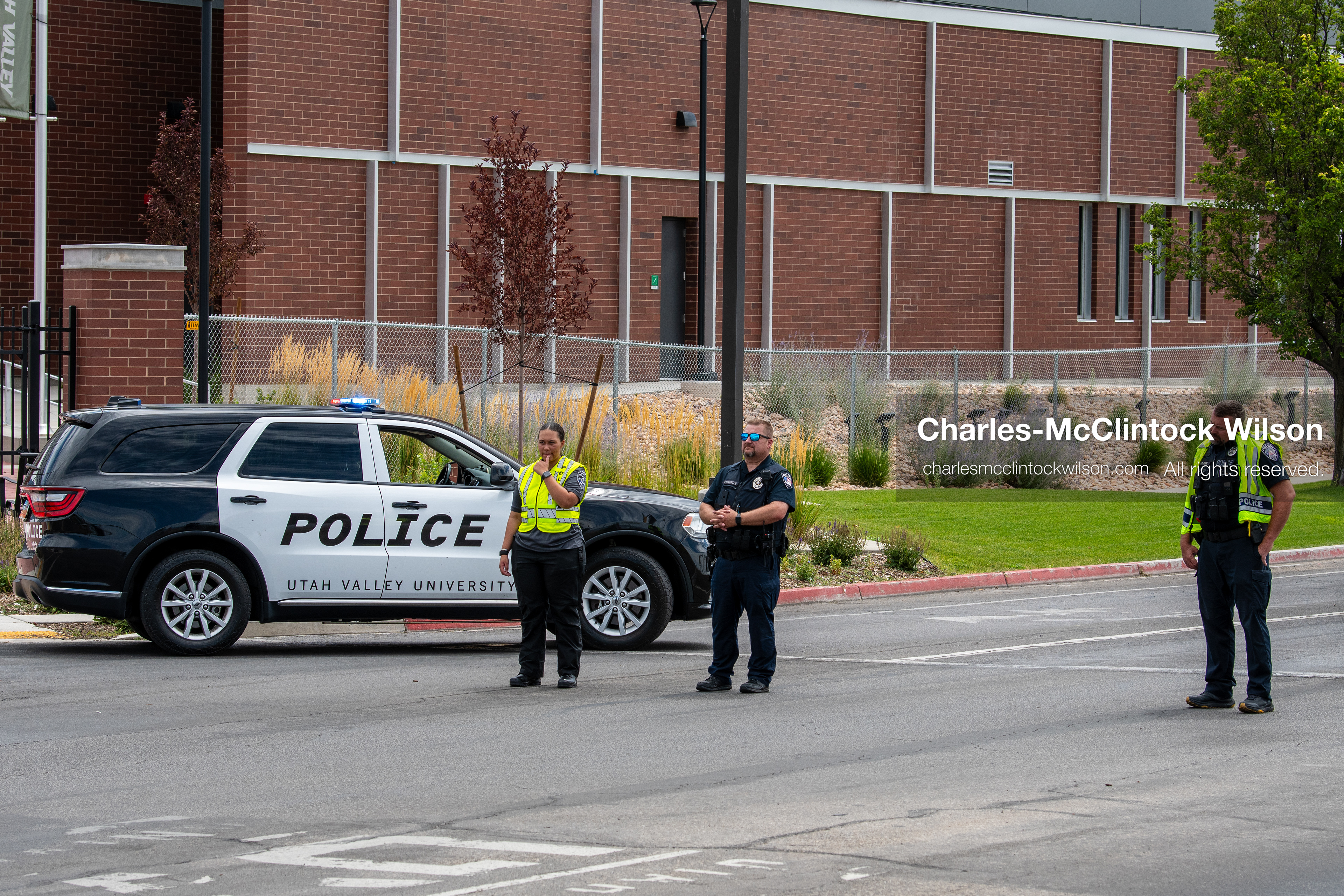 Law enforcement officers block and direct traffic near parked police cruisers outside the UCCU Center at Utah Valley University in Orem, Utah, on Wednesday, July 29, 2026. More than 300 people came to the public memorial ceremony to honor Provo Fire Captain Spencer Long, his wife Katrina, and three of their sons, who died after a flash flood hit their campsite near the Sunglow Campground in Wayne County. (Photo by Charles-McClintock Wilson/Sipa USA)