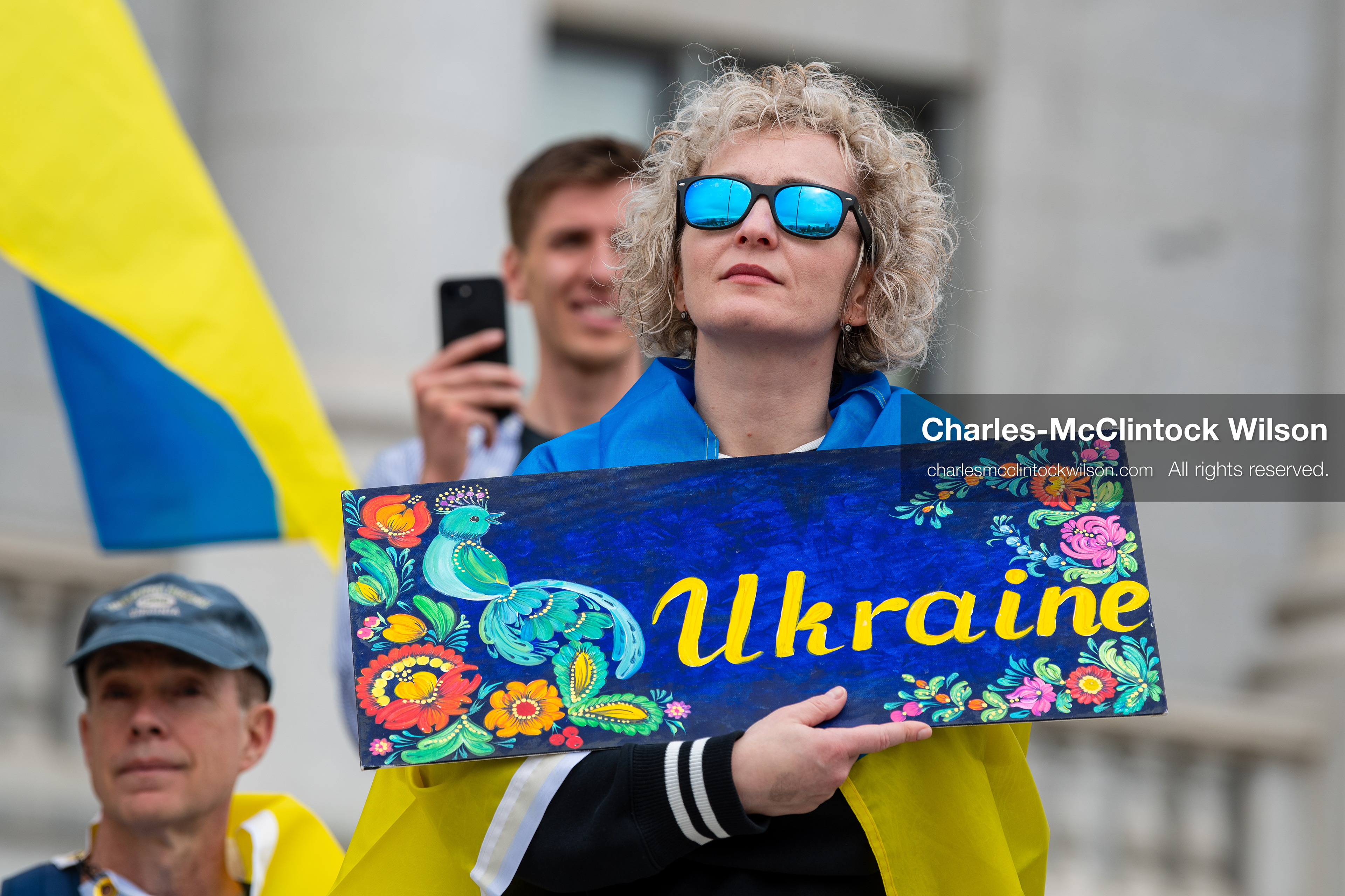 February 28, 2026, Salt Lake City, Utah, USA: A demonstrator draped in a Ukrainian flag holds a hand painted sign reading Ukraine during the Stand With Ukraine rally at the Utah State Capitol. The gathering marked the four year anniversary of the full scale Russian invasion of Ukraine and brought community members together in support of Ukrainians and local humanitarian efforts. (Credit Image: © Charles McClintock Wilson/ZUMA Press Wire)