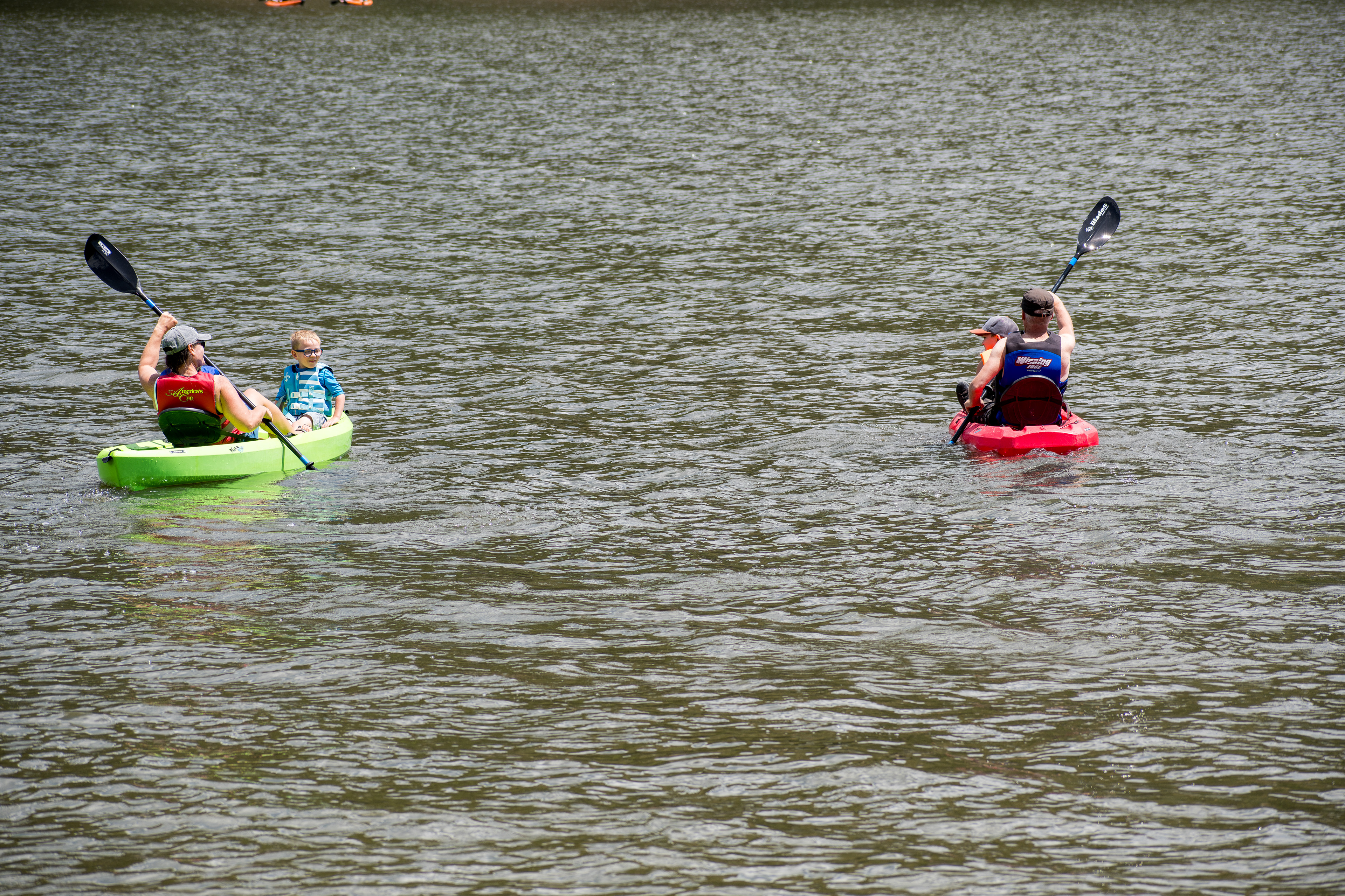 Summit County, Utah – July 20, 2025: People paddle kayaks across the calm waters of Smith and Morehouse Reservoir during a summer outing.
