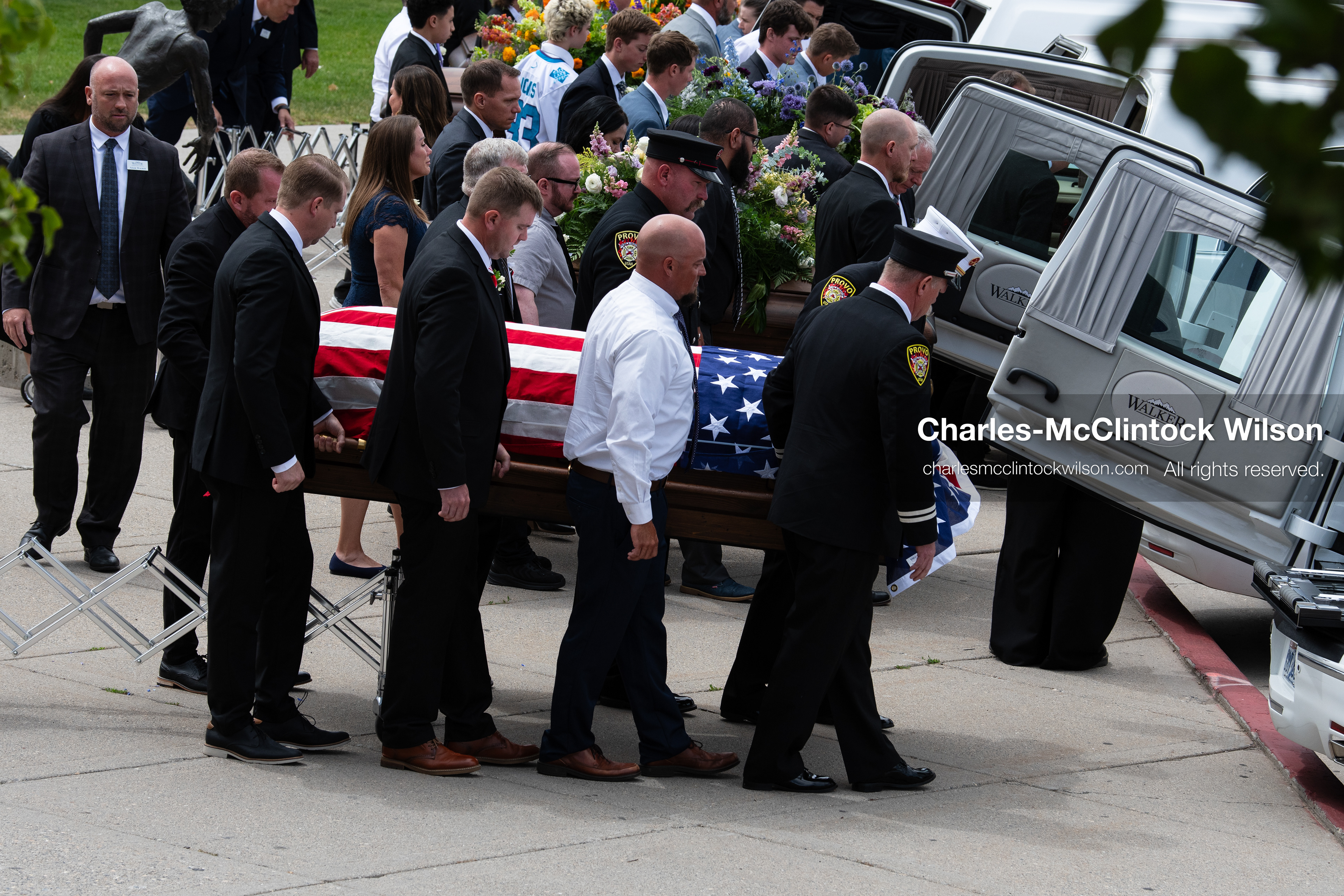 Firefighters and pallbearers load the flag-draped casket of Provo Fire Captain Spencer Long into a white hearse outside the UCCU Center at Utah Valley University in Orem, Utah, on Wednesday, July 29, 2026. More than 300 people came to the public memorial ceremony to honor Captain Long, his wife Katrina, and three of their sons, who died after a flash flood hit their campsite near the Sunglow Campground in Wayne County. (Photo by Charles-McClintock Wilson/Sipa USA)