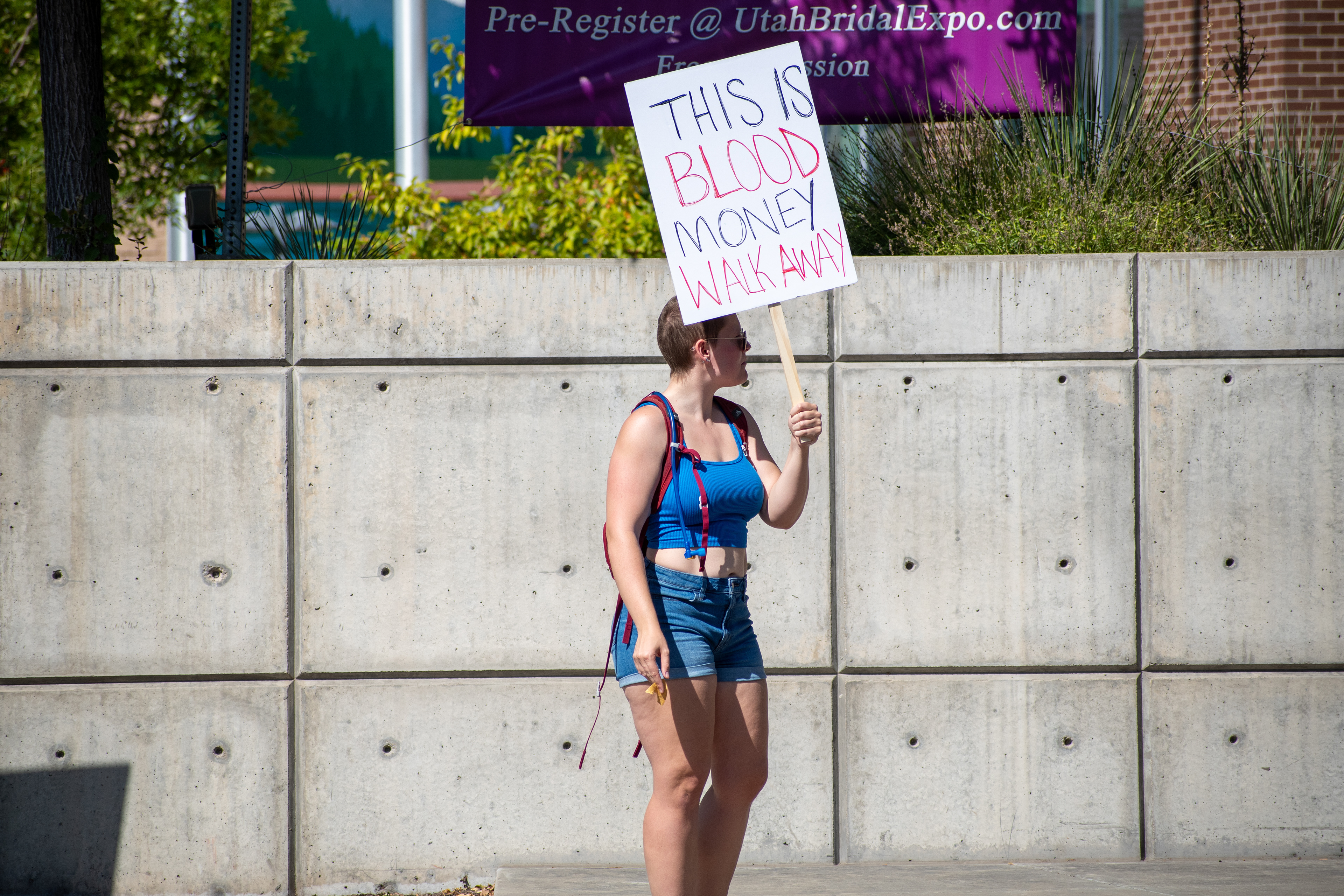 September 15, 2025 – Provo, Utah, United States: A demonstrator holds a sign reading “THIS IS BLOOD MONEY WALK AWAY” outside the Utah Valley Convention Center during a protest against the Department of Homeland Security career expo. The message critiques federal recruitment and calls for moral disengagement. Photograph by Charles‑McClintock Wilson / ZUMA Press Wire